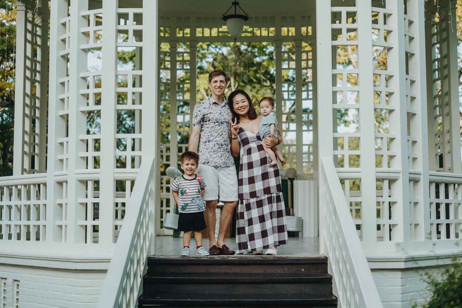 Three photographs taken at a gazebo with white lattice walls and columns showing cozy family moments in natural lighting.