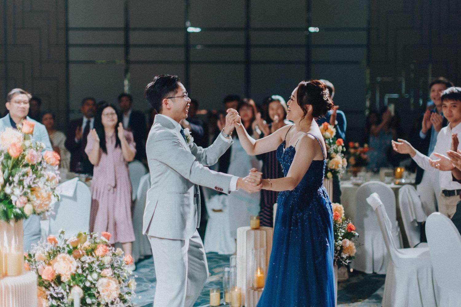 Wedding celebration showing guests in formal wear dancing and celebrating.