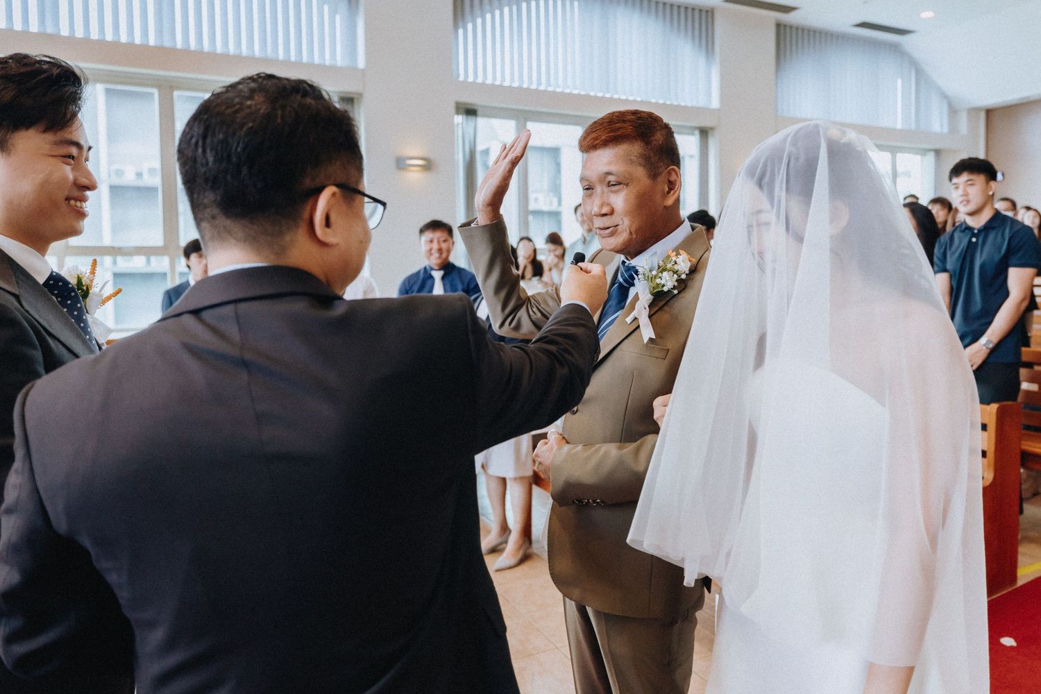 Father of the bride walks daughter down the aisle during emotional church wedding ceremony.