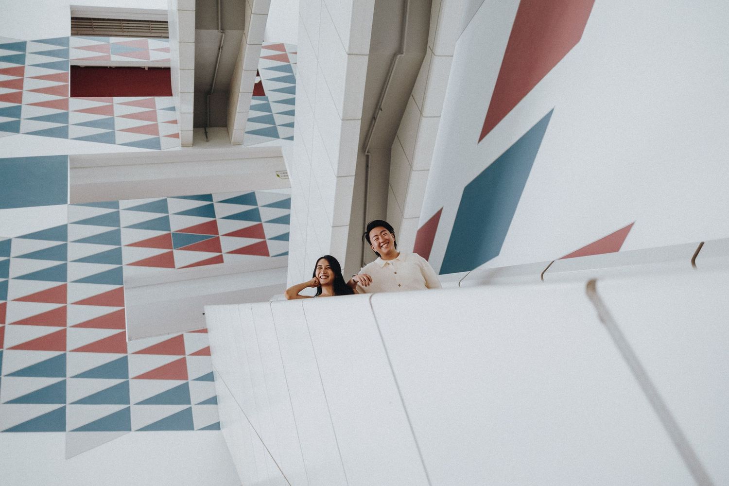 Modern geometric wall patterns create an artistic backdrop in a minimalist interior space.