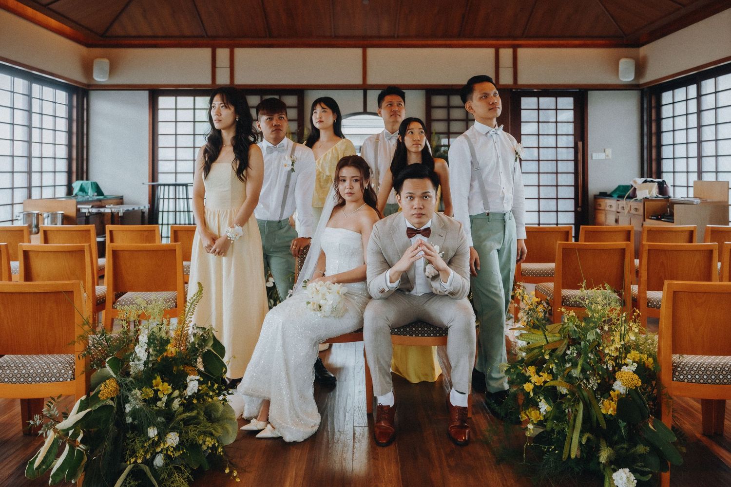 Wedding party gathers in a traditional Japanese-style room with wooden floors and paper screen windows.