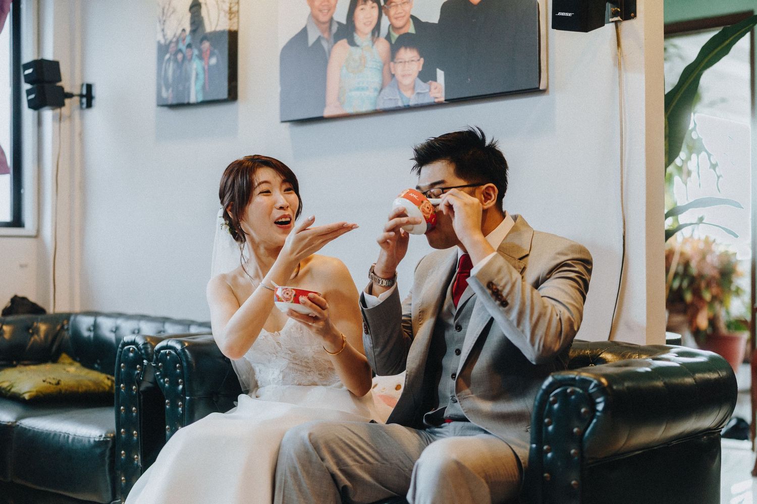 Guests seated on a couch in a modern living room setting with wall art.