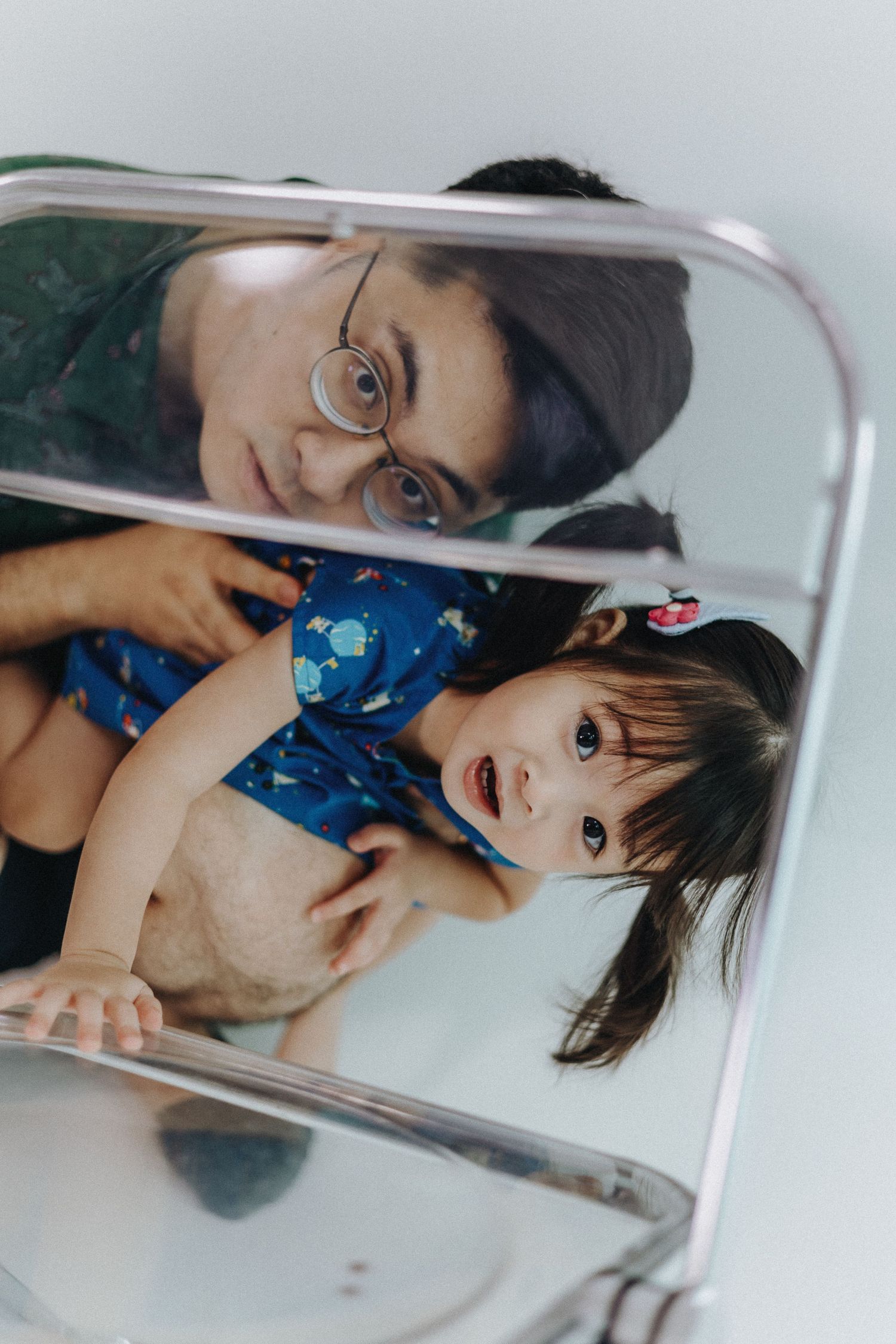 Creative mirror reflection portraits capturing playful family interactions.