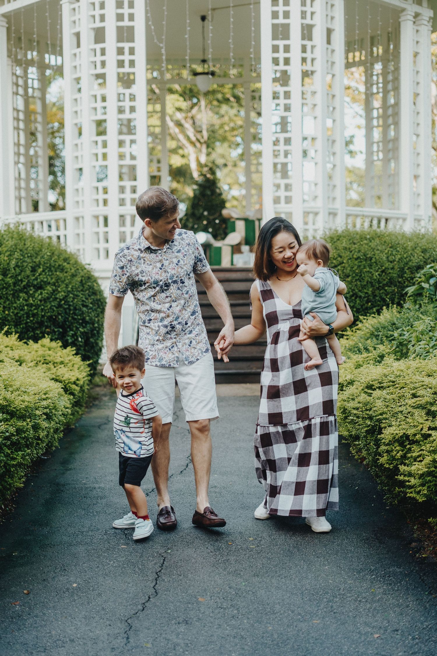 Happy group walking and playing together on a garden path while wearing coordinated black and white outfits.