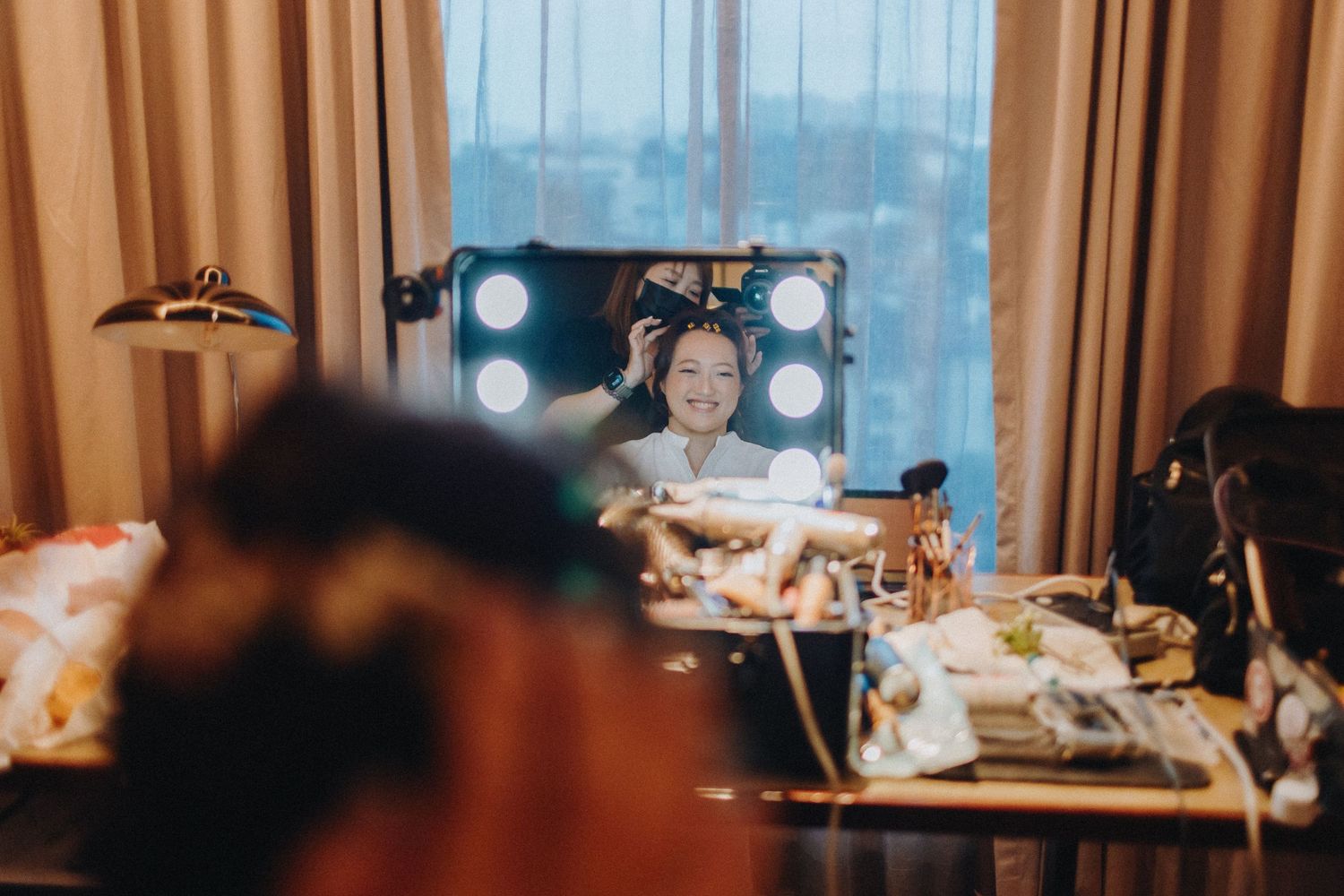 Couple shares a tender moment during their first look wedding photos in a warmly lit room.