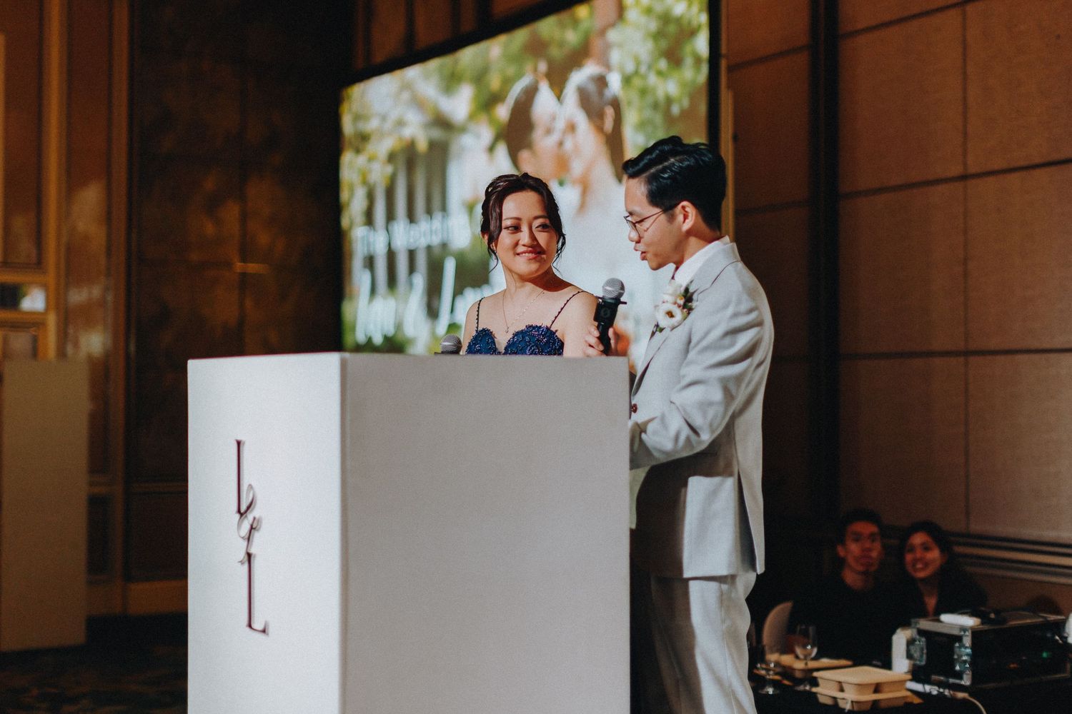 Couple sharing tender moments in an elegant wood-paneled hallway.