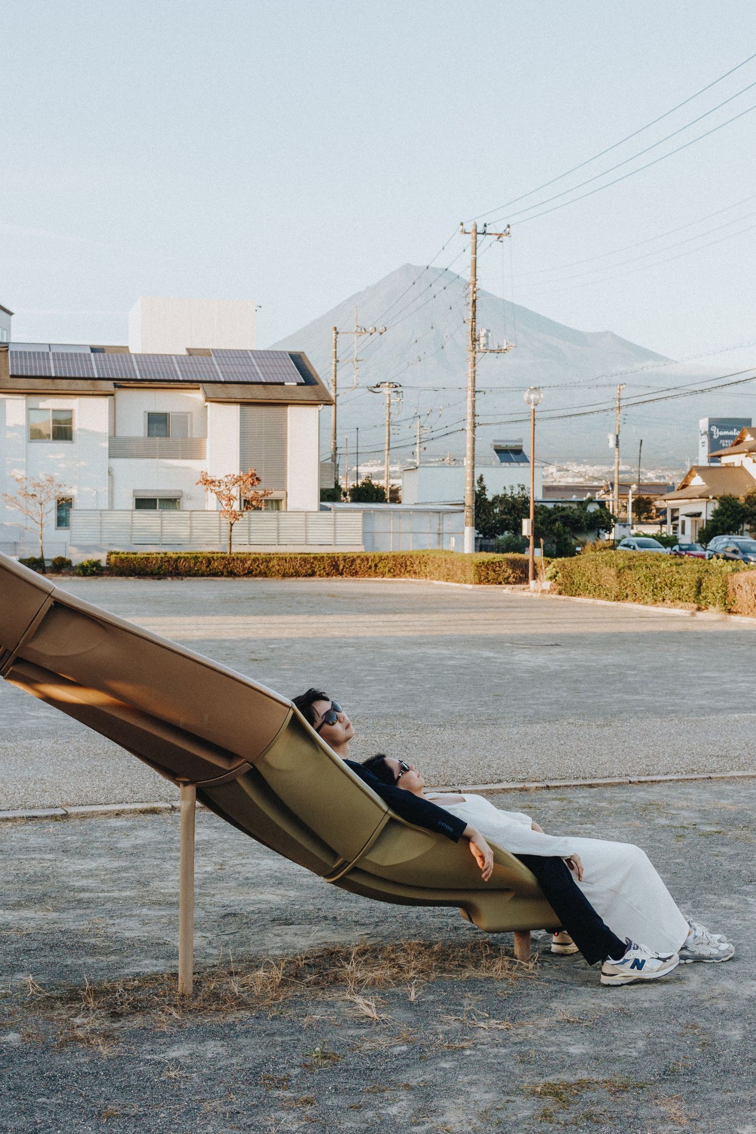 Modern seating arrangement at an outdoor venue with mountain backdrop.