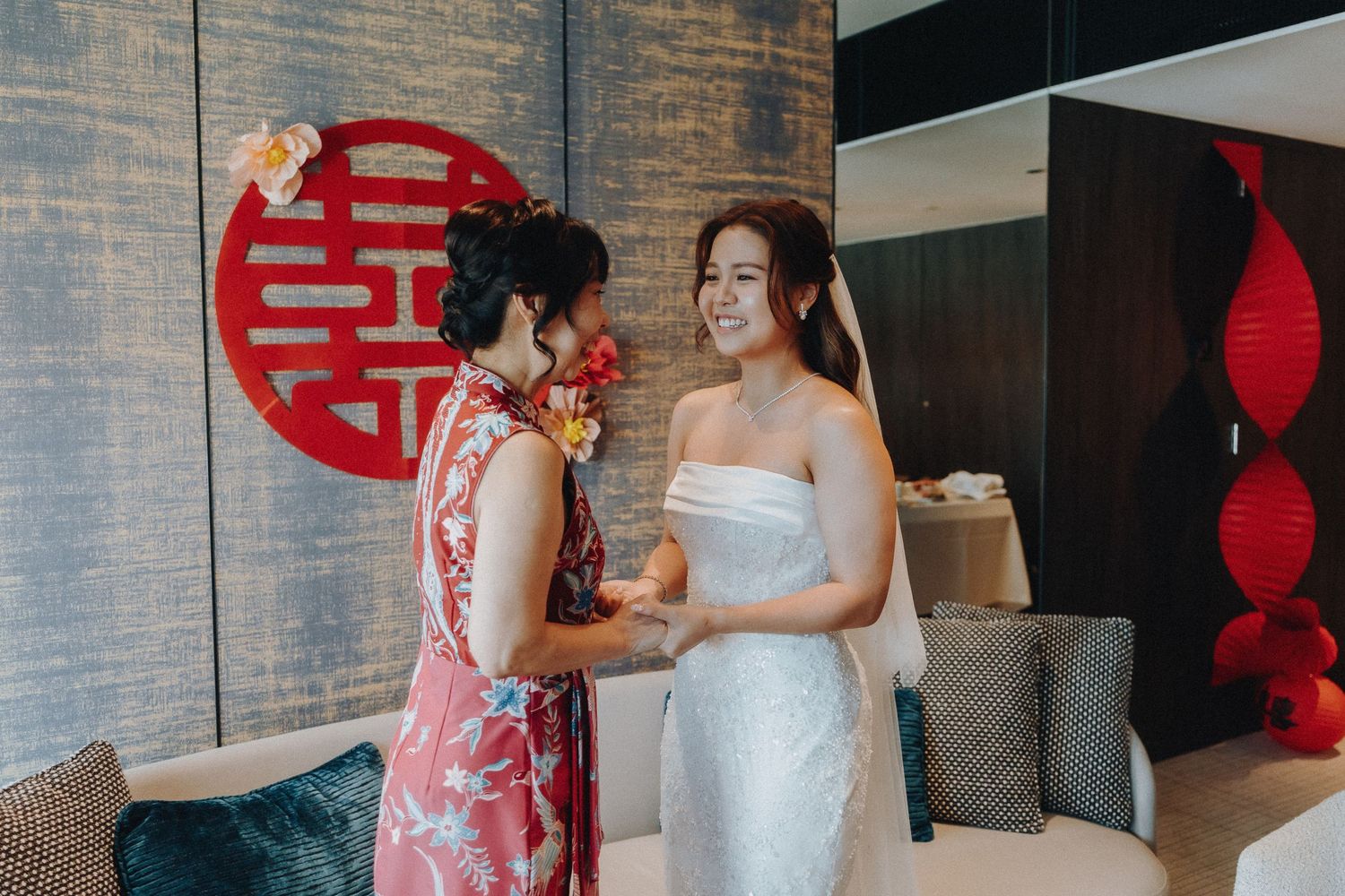 Traditional Chinese wedding ceremony with double happiness symbol and bride in white dress.