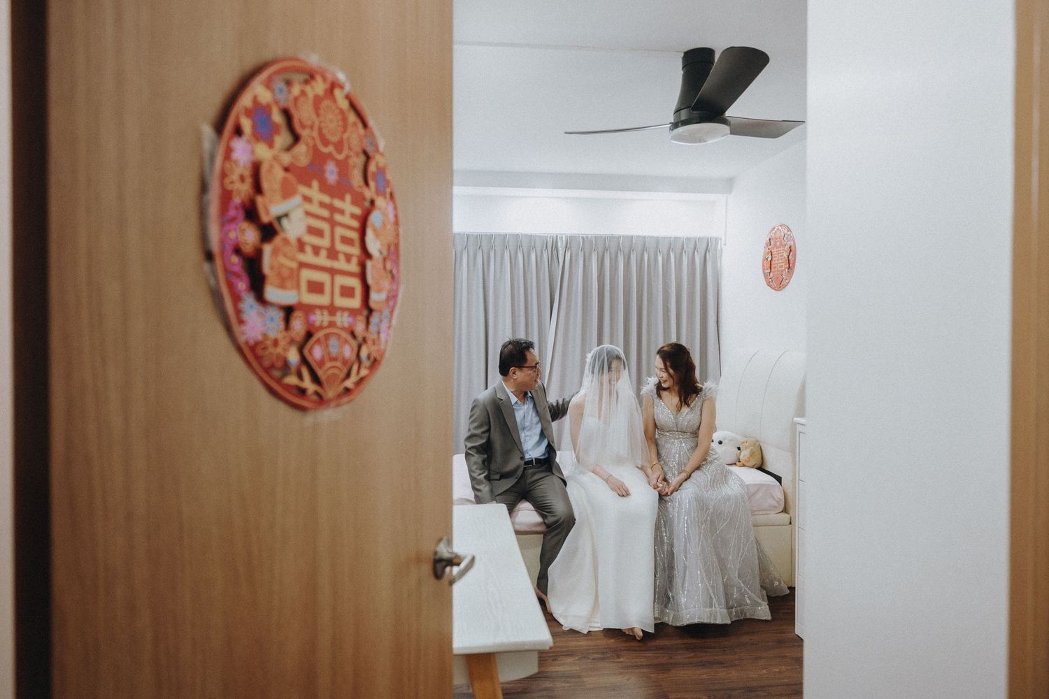 A collection of paper butterfly decorations hang on wooden wall panels in an artistic display.