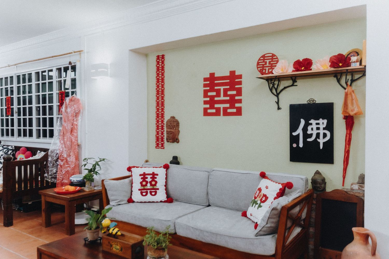 Asian-themed room interior with lucky red decals and traditional decorations displayed along white painted walls.