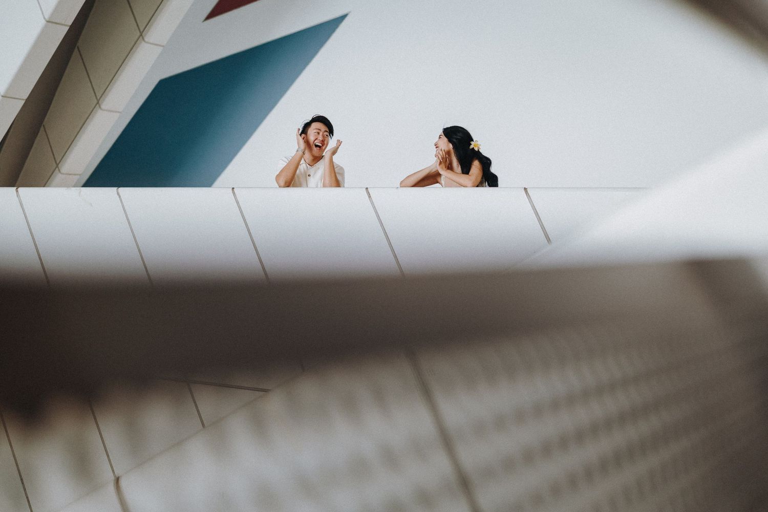 Contemporary building interior features clean lines and geometric patterns in white and teal.