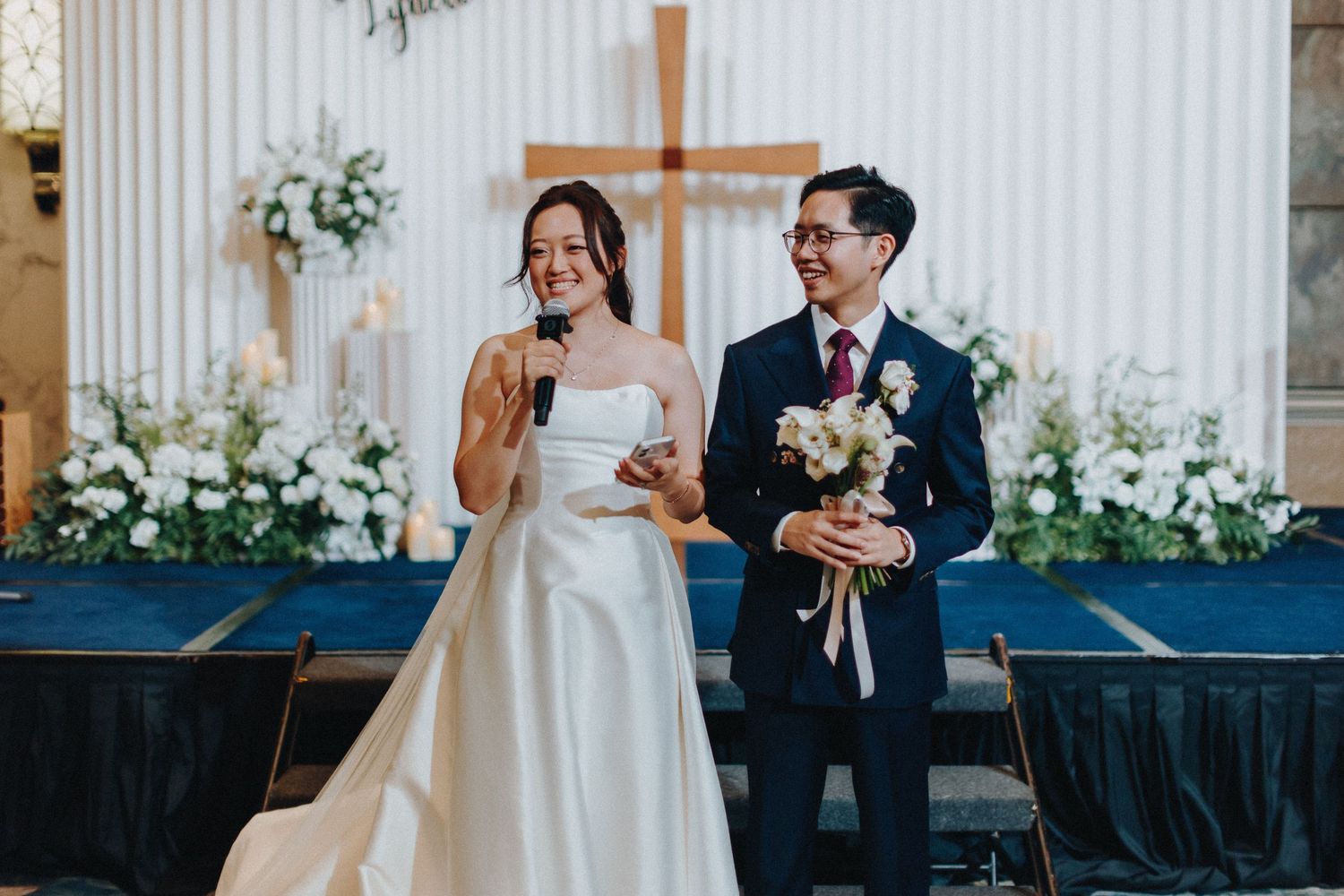 Elegant wedding ceremony setup with white panels and floral arrangements in peach tones.