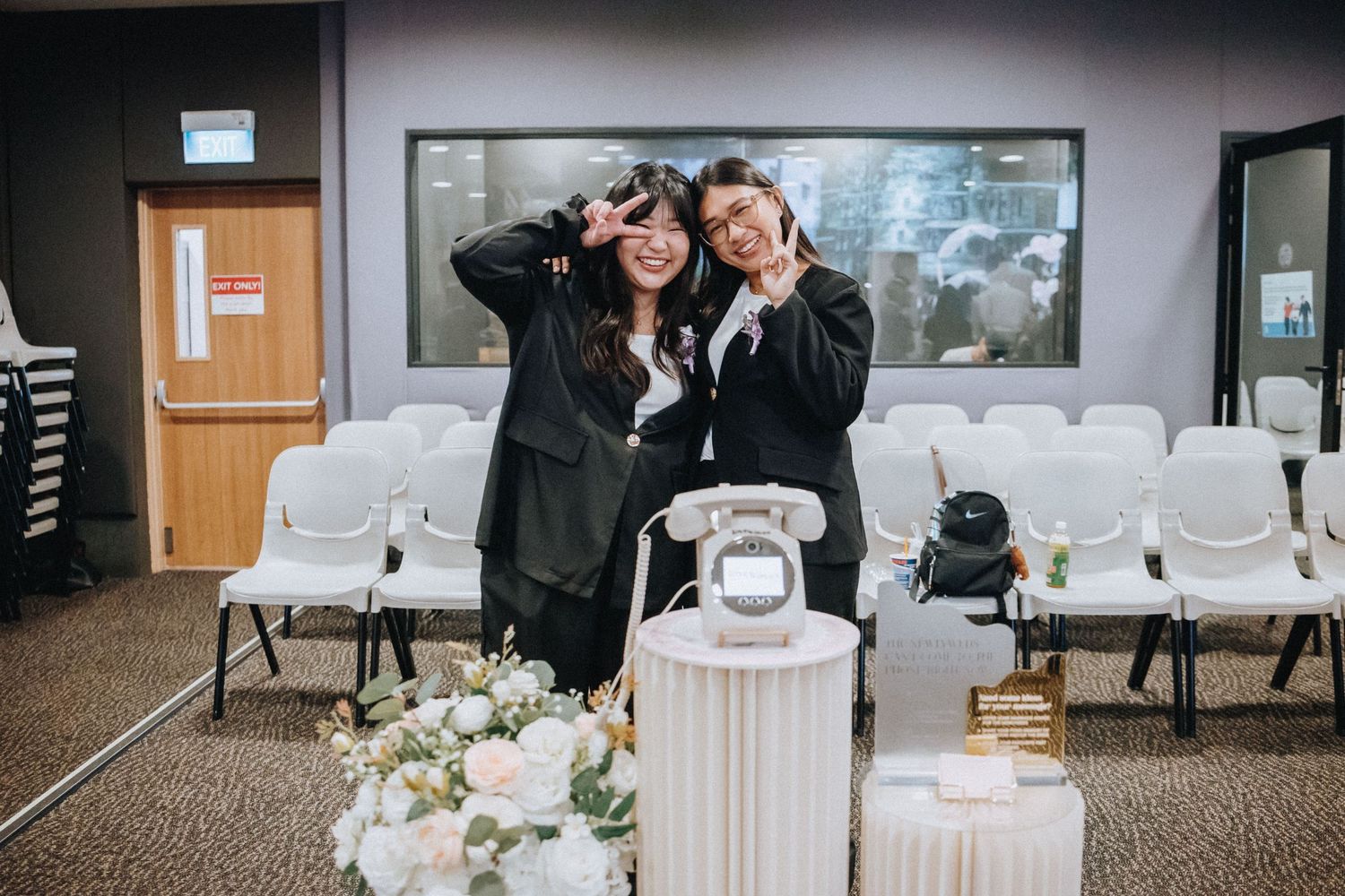 Modern wedding venue setup with white chairs and minimalist decor.
