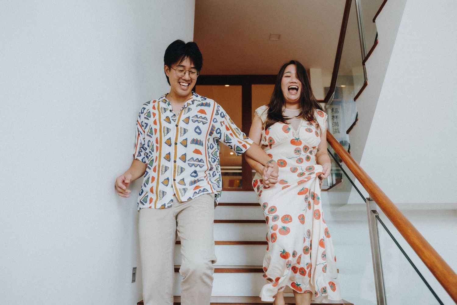 Wedding guests celebrating joyfully on a staircase in matching outfits.
