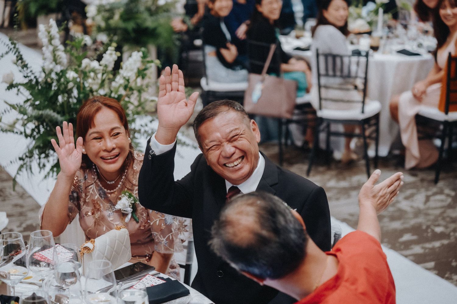Candid reception celebration moments captured in a series of joyous black and white photographs at an outdoor wedding.