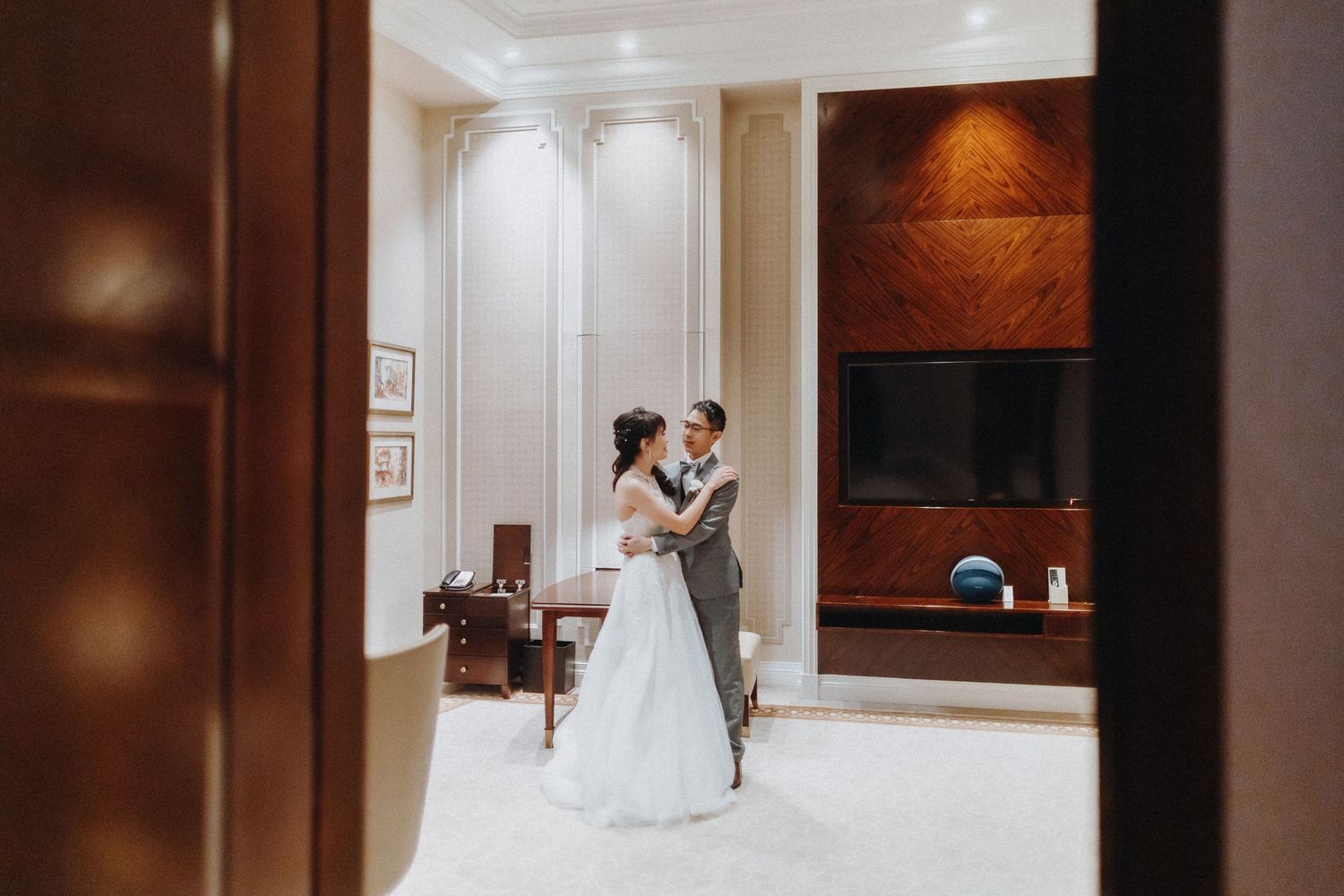 Wedding celebration moments captured in an elegant wood-paneled hallway.