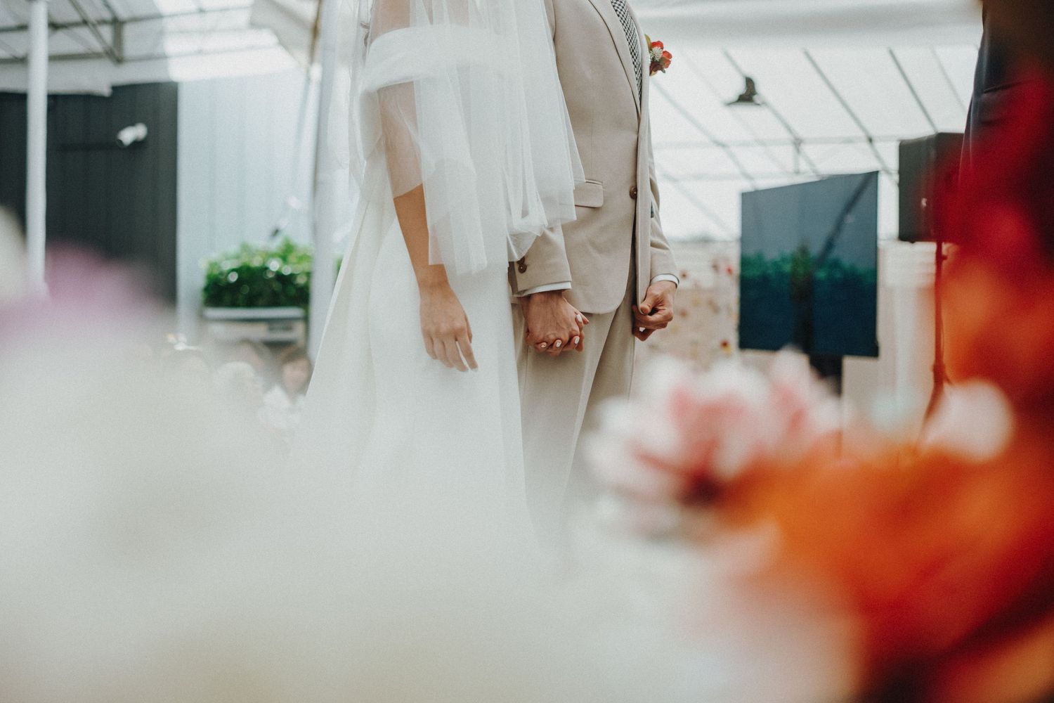 Wedding detail shot focusing on the bottom portion of formal attire and delicate movements.