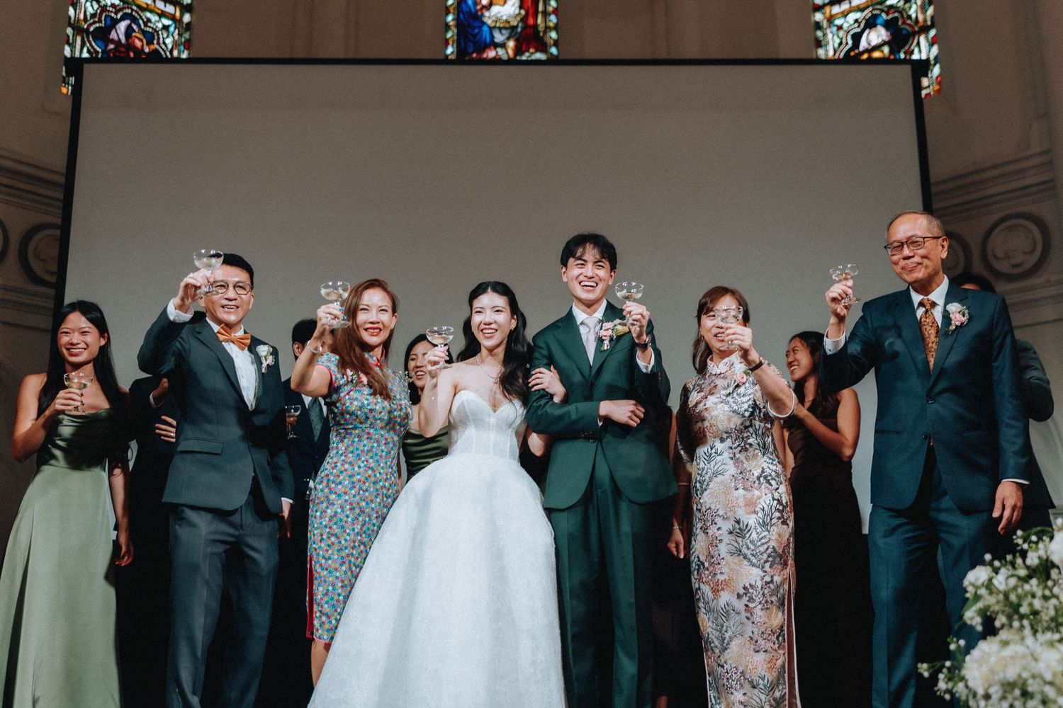 Wedding party group toast with bride and groom in church ceremony.
