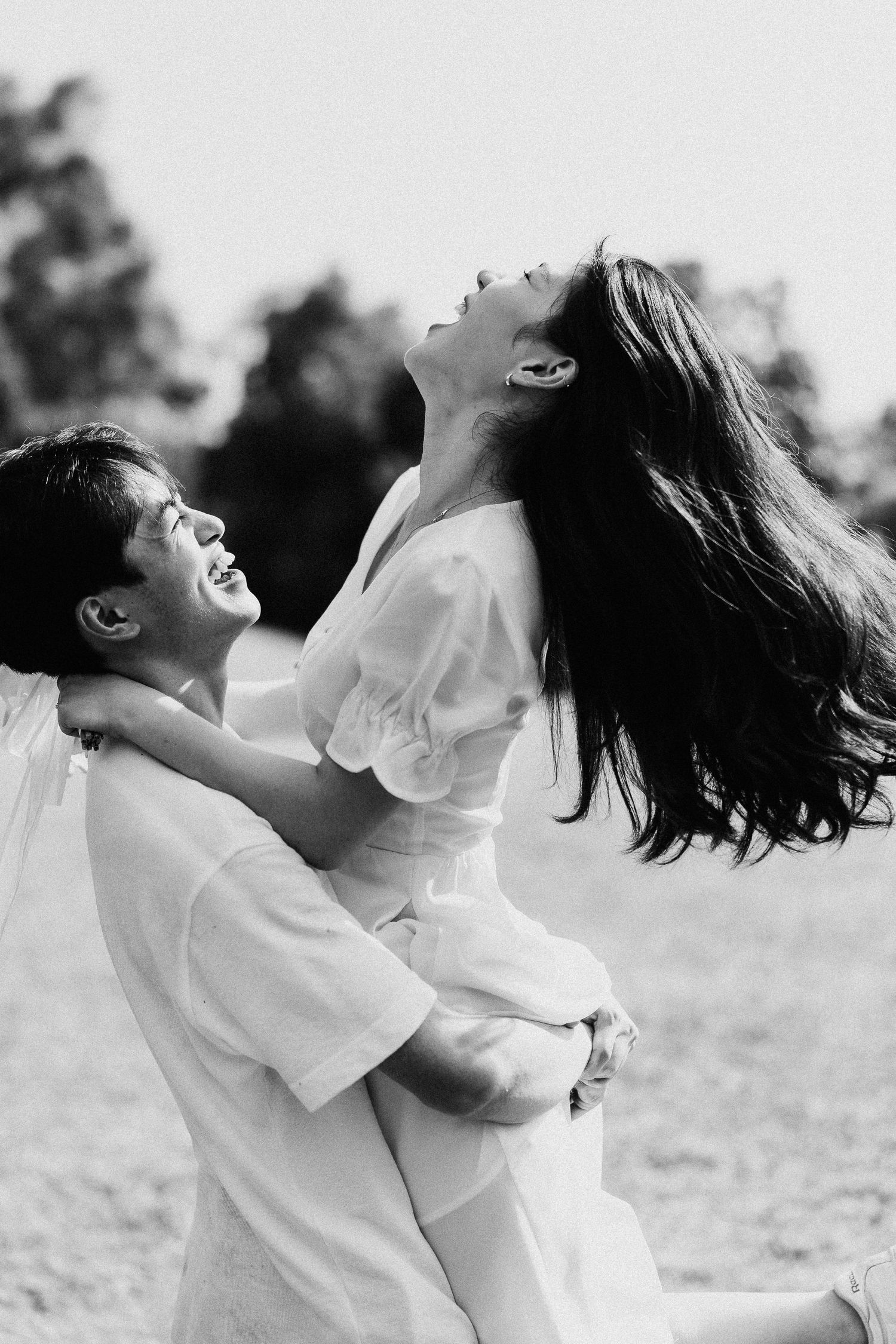 A dynamic black and white photo capturing a playful lift in an outdoor setting.