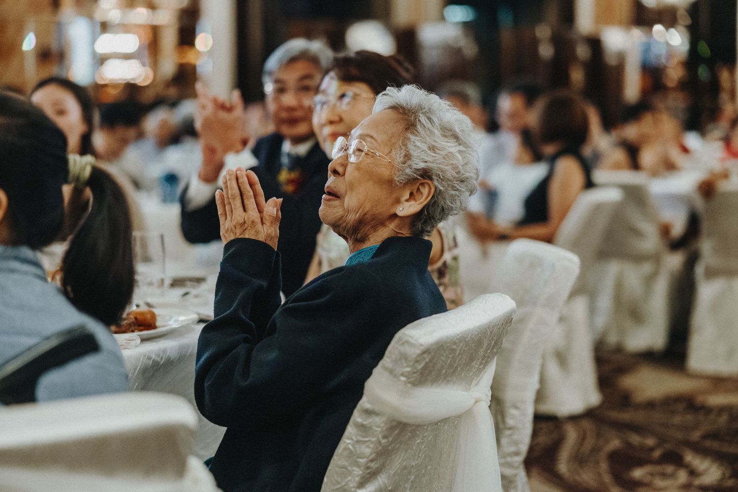 Wedding reception celebration with guests raising glasses for a toast.