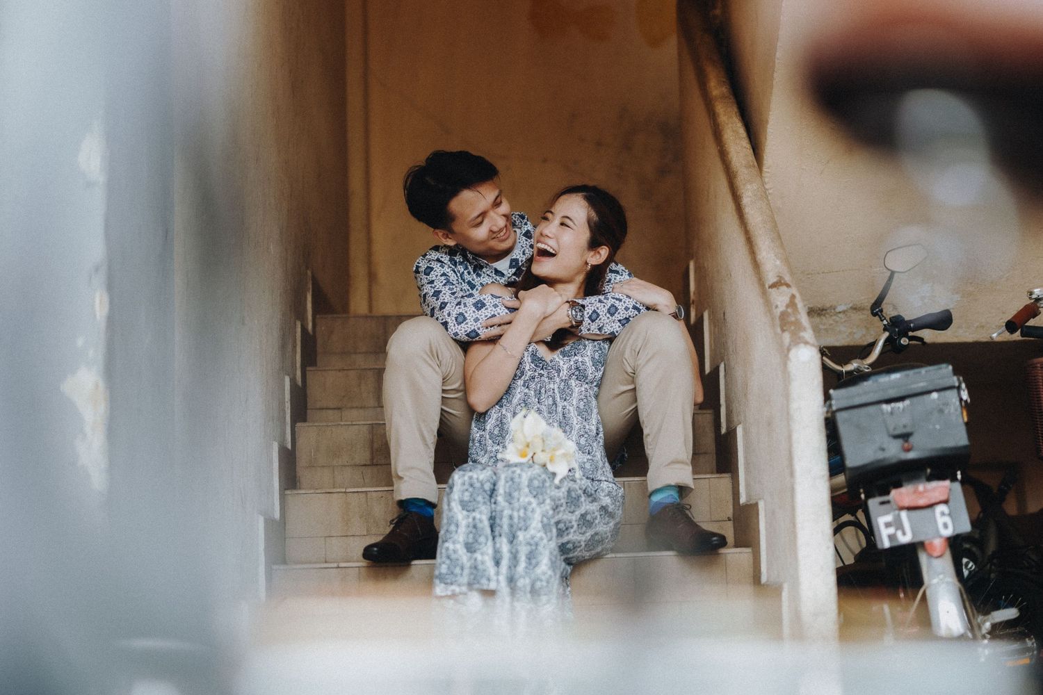 Candid moments of a couple laughing and embracing in a casual indoor setting.