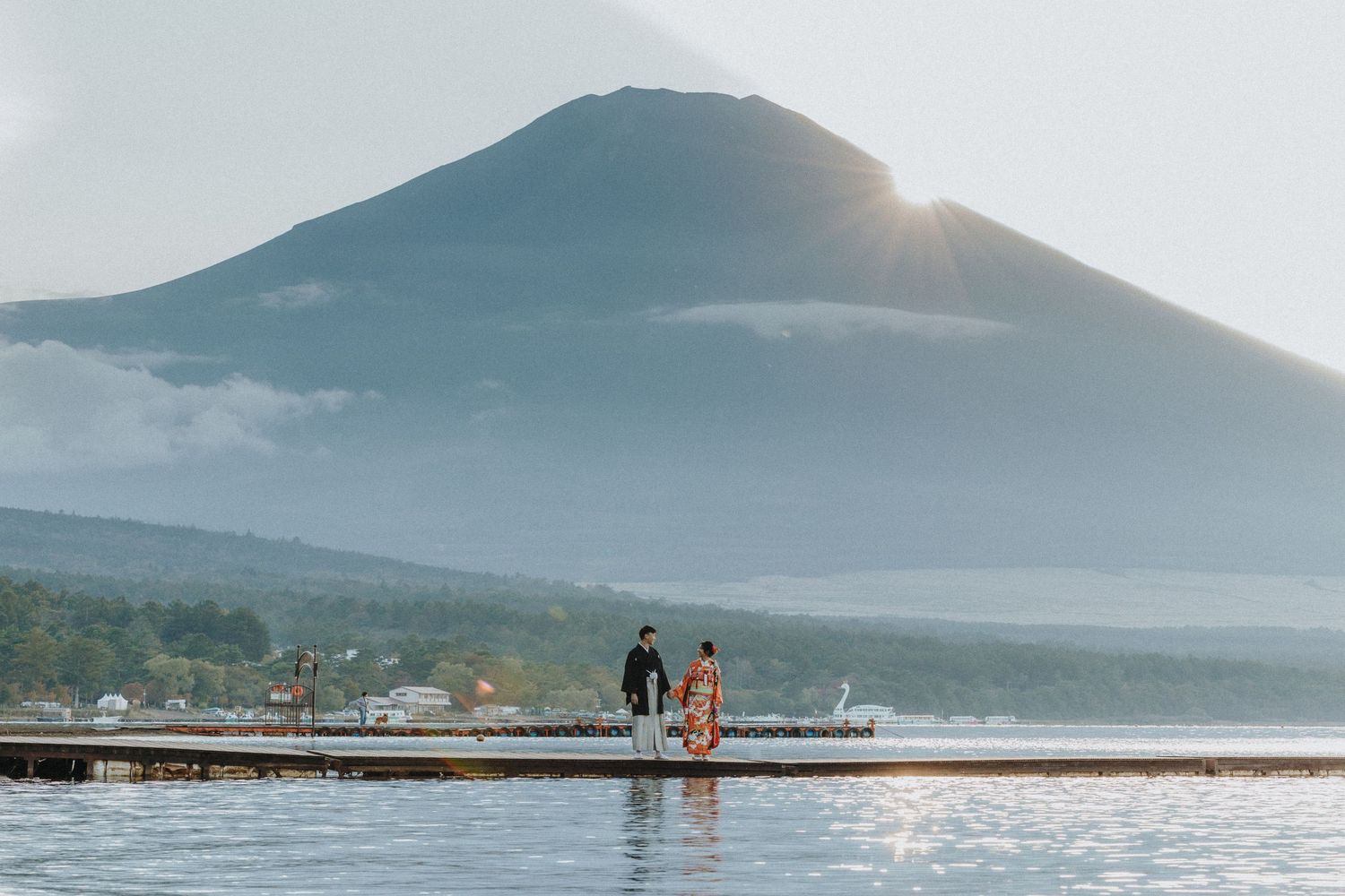 Panoramic view of majestic mountain peak overlooking calm waters during golden hour.