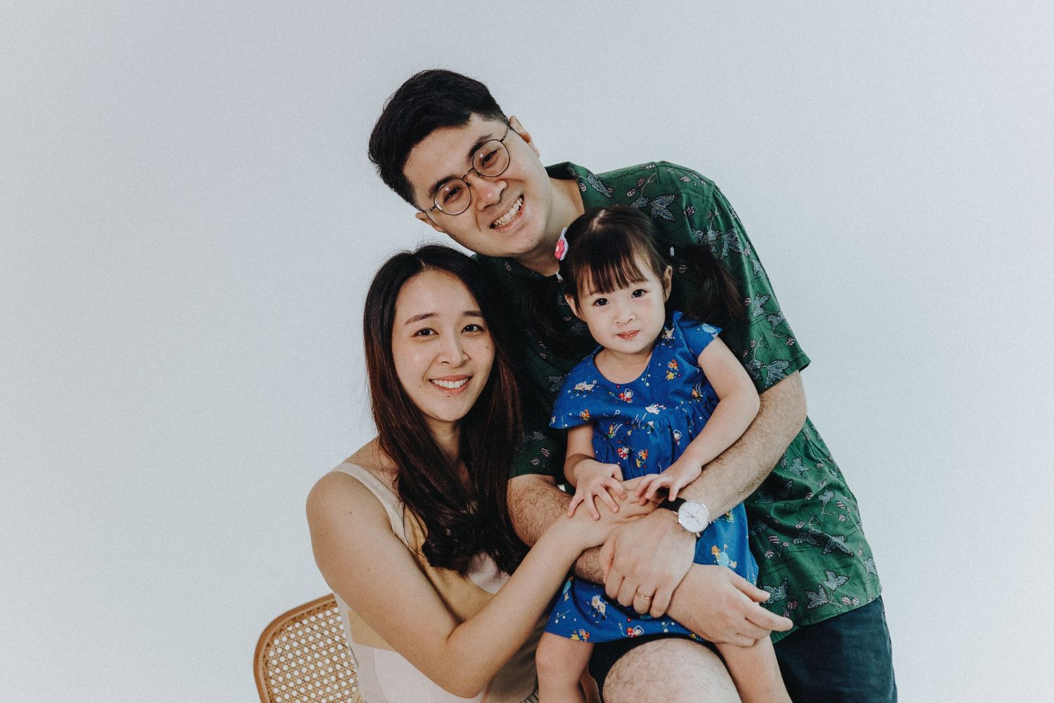 Sweet family portraits in casual attire against a simple white backdrop.