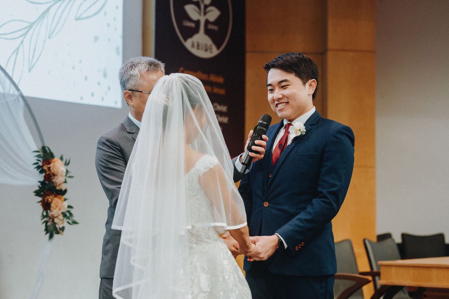 Emotional wedding ceremony moment in a modern church sanctuary.