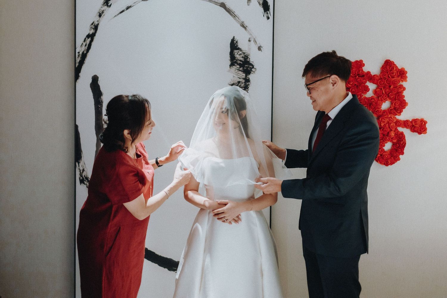 Bridal party in navy blue dresses and white gown celebrating in a modern indoor setting.