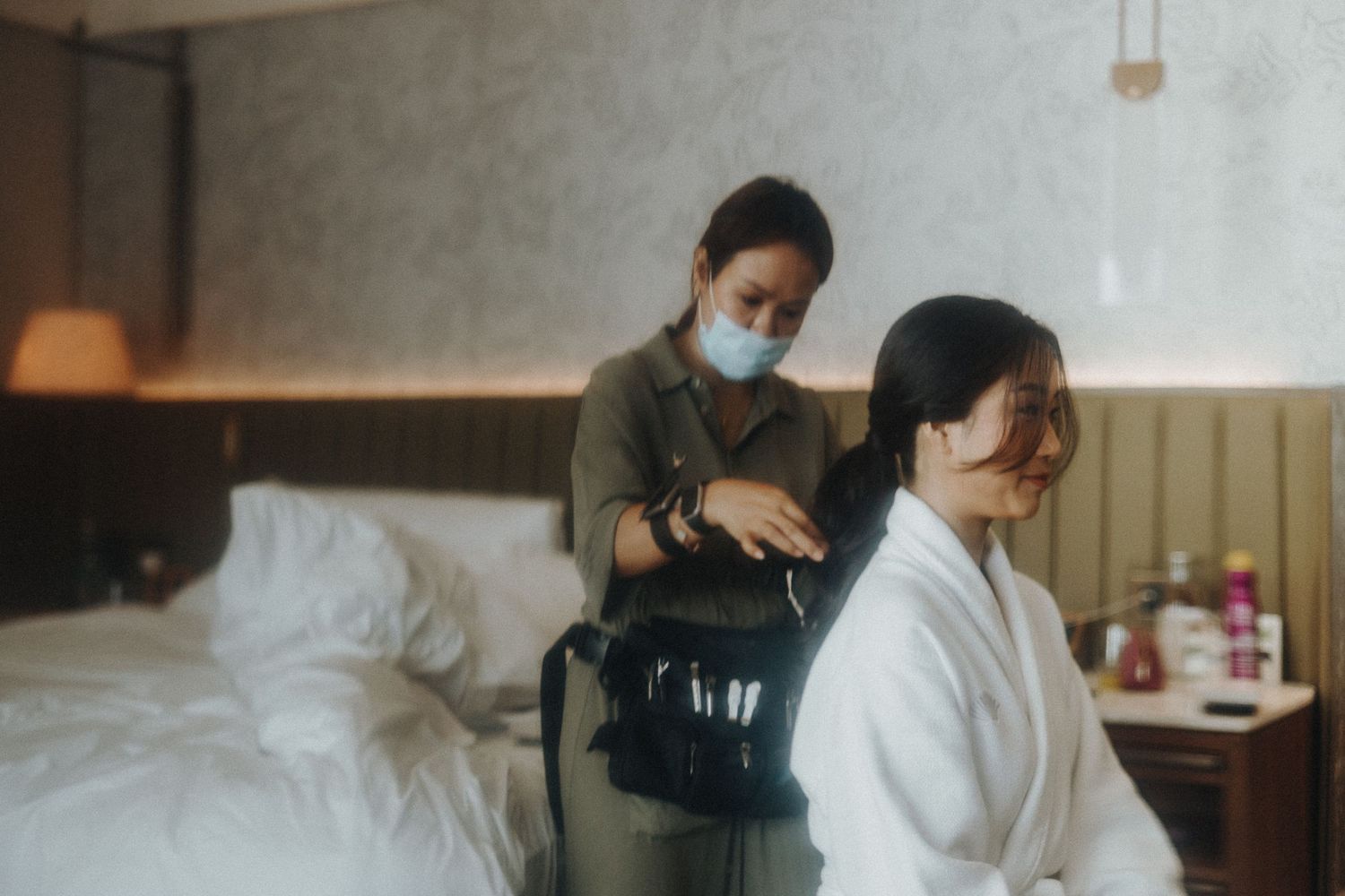 A series of photographs showing preparation and donning of surgical face masks in a medical setting.