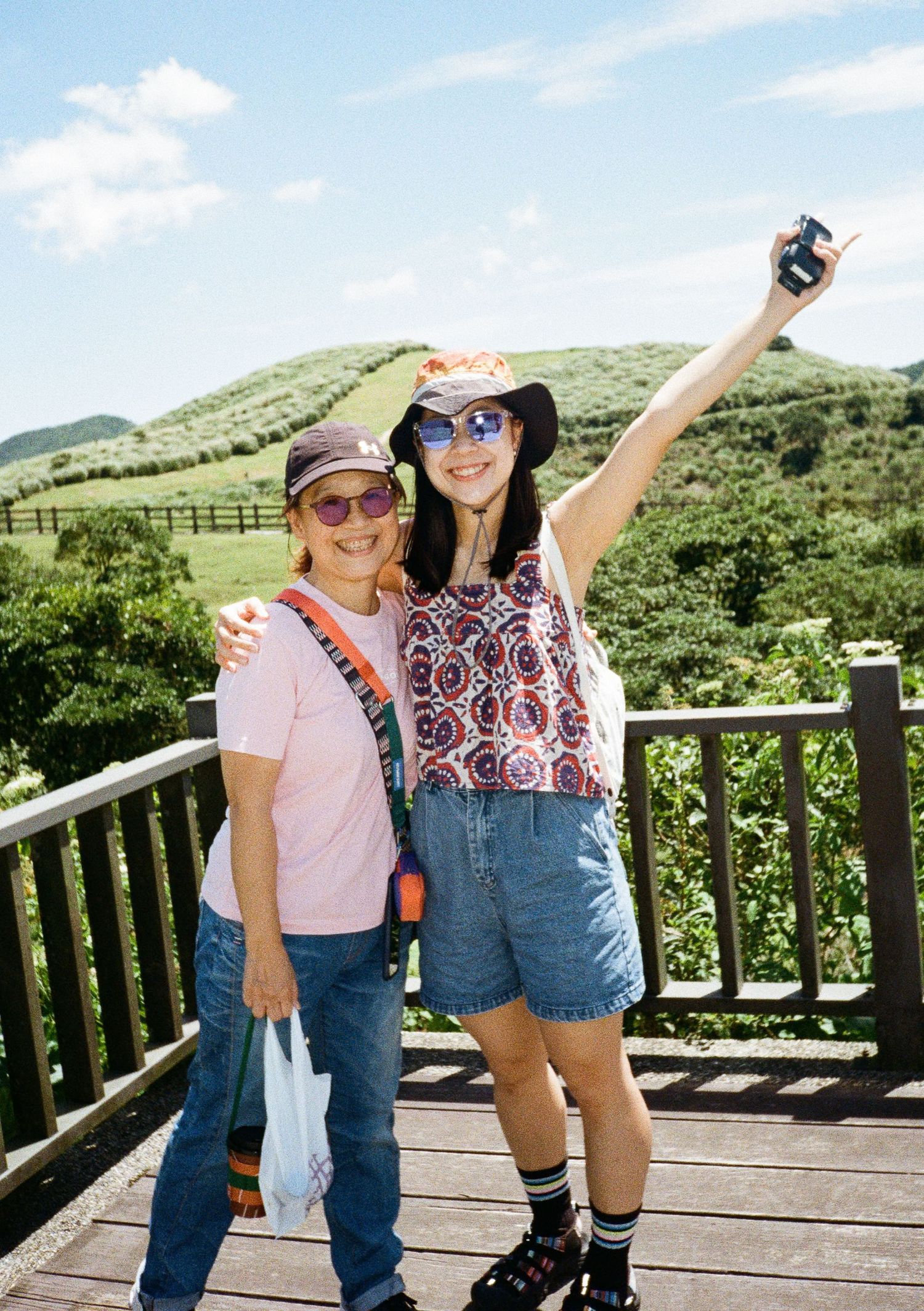 Scenic observation deck overlooking green rolling hills on a sunny day.