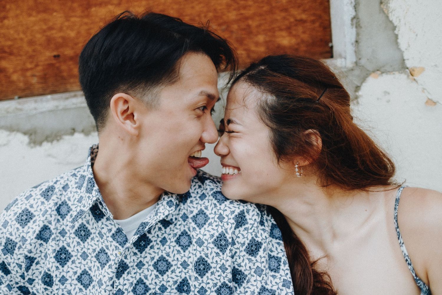 A tender close-up moment between a couple wearing coordinated outfits.