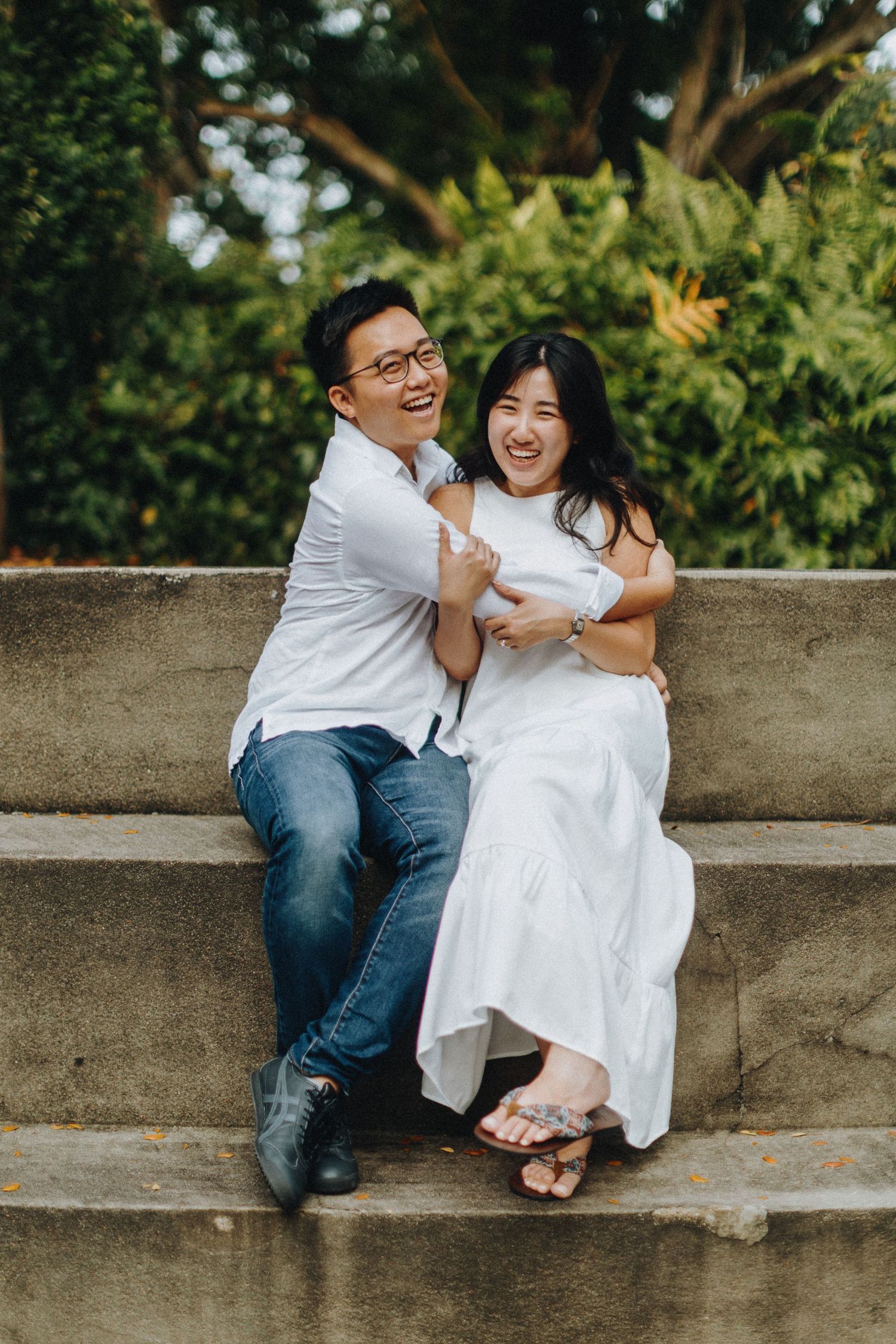 Romantic candid photo sequence of a couple sitting and laughing together on concrete steps outdoors.