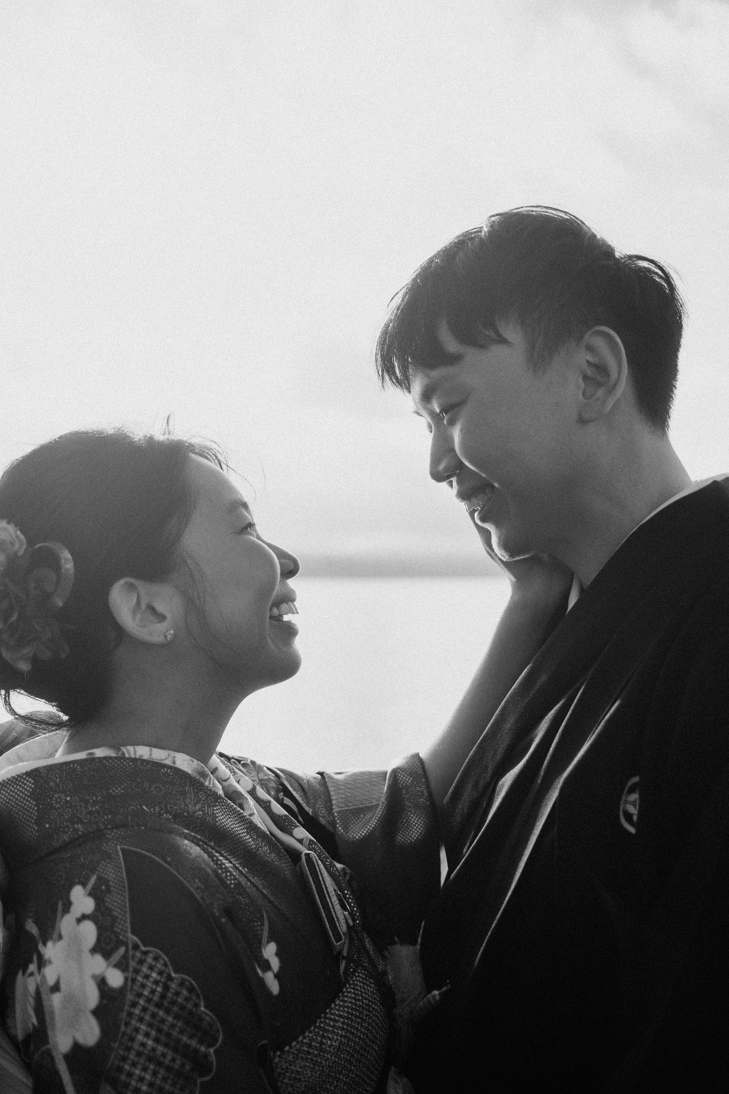 Silhouetted profiles show an intimate black and white moment between two people.