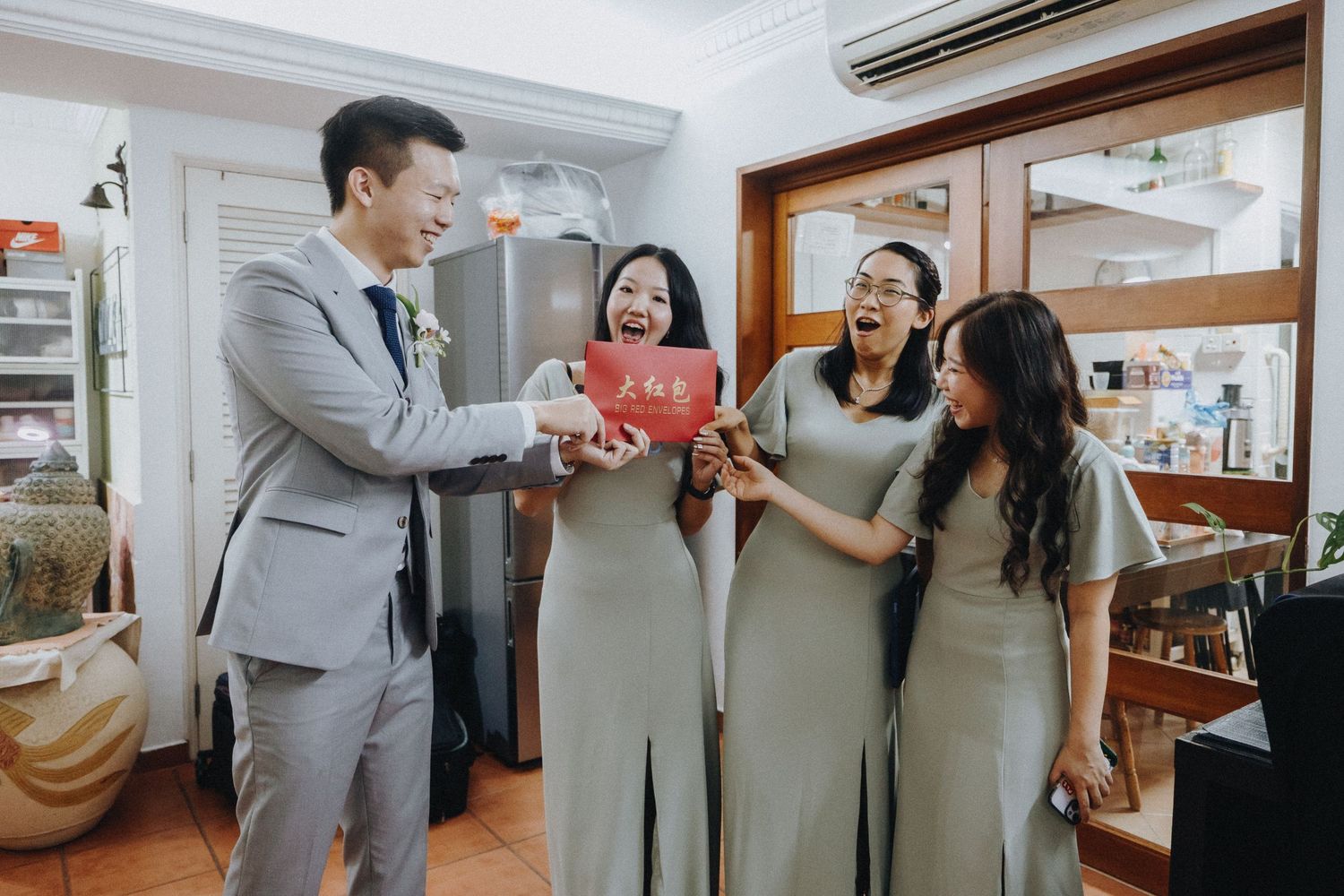 Wedding celebration in white modern interior with guests sharing candid moments.