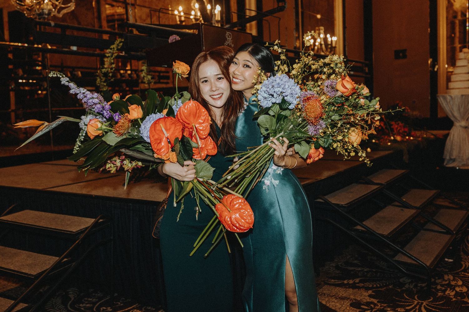 Wedding reception venue decorated with elaborate floral arrangements and mood lighting.