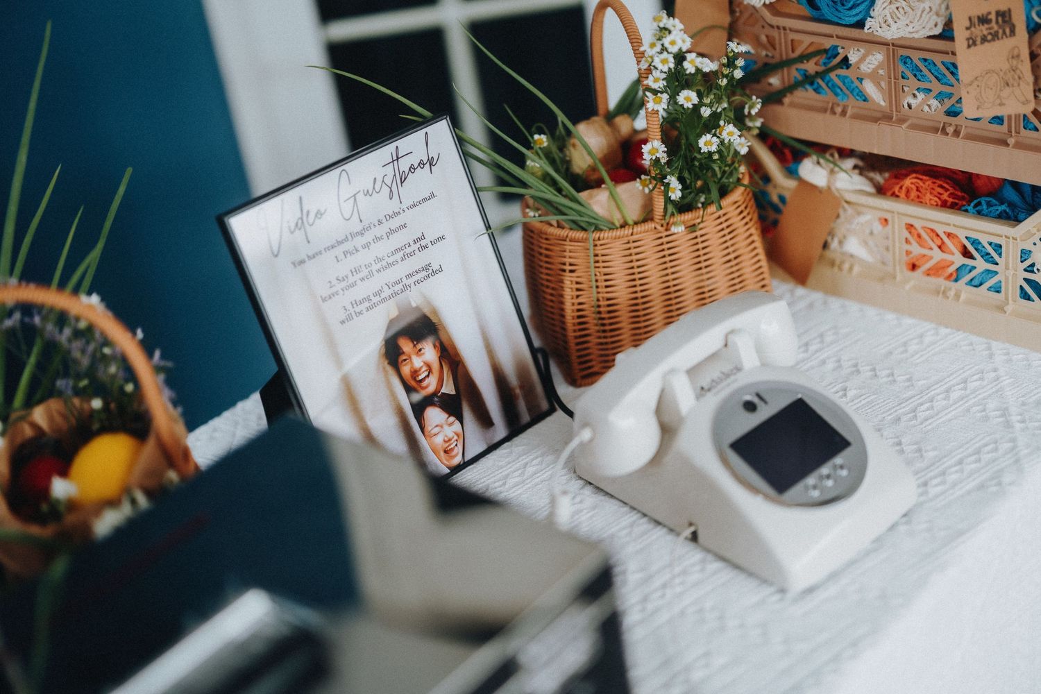 Desk setup with notebooks, flowers, and personal items in natural light.