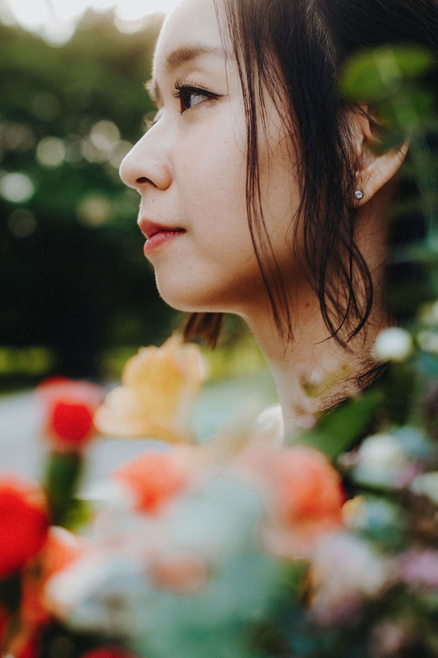 Artistic close-up profile shots of someone amid blurred flowers with soft bokeh effects in the background.