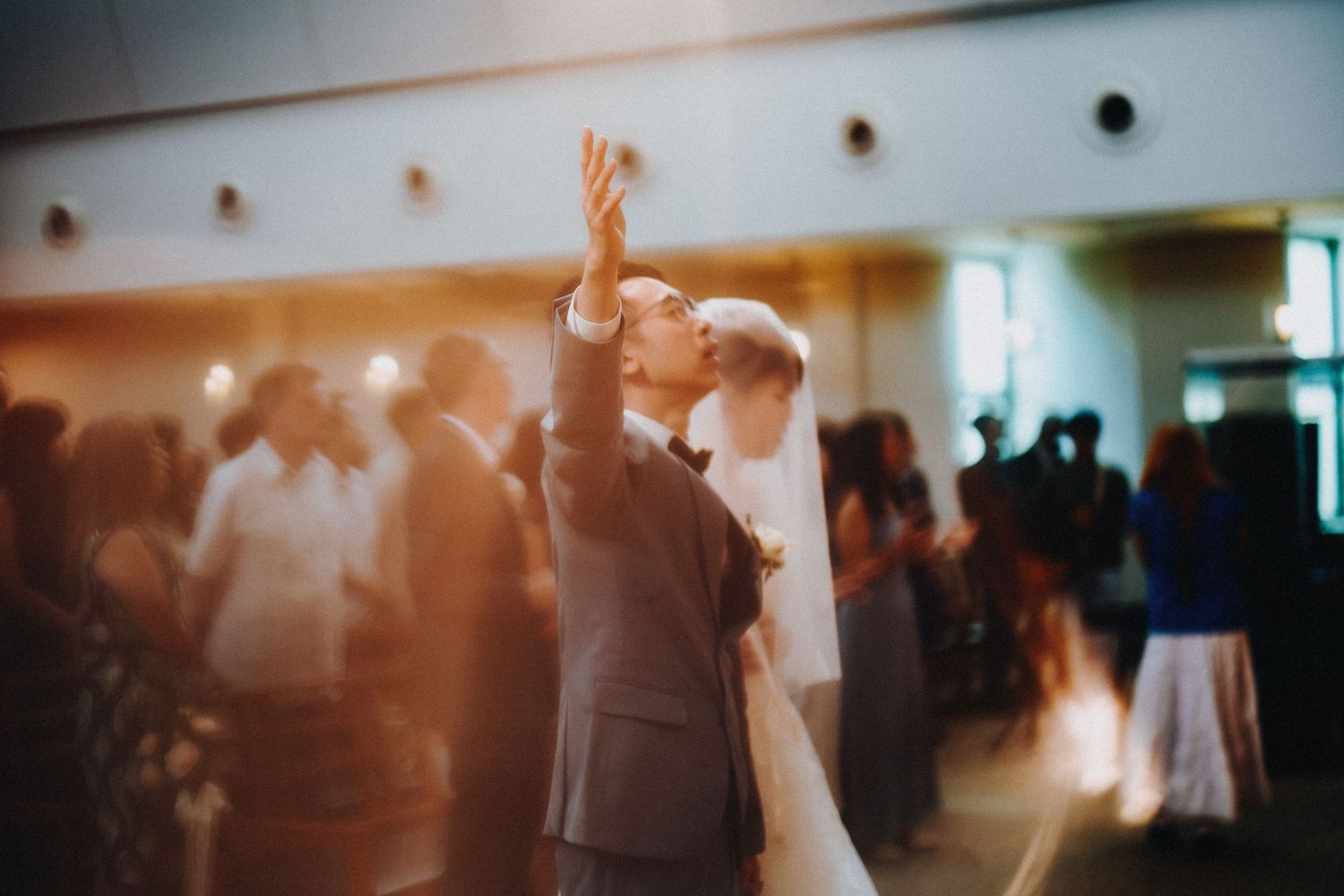 Blurred motion shots of a crowded dance floor at a celebration event.