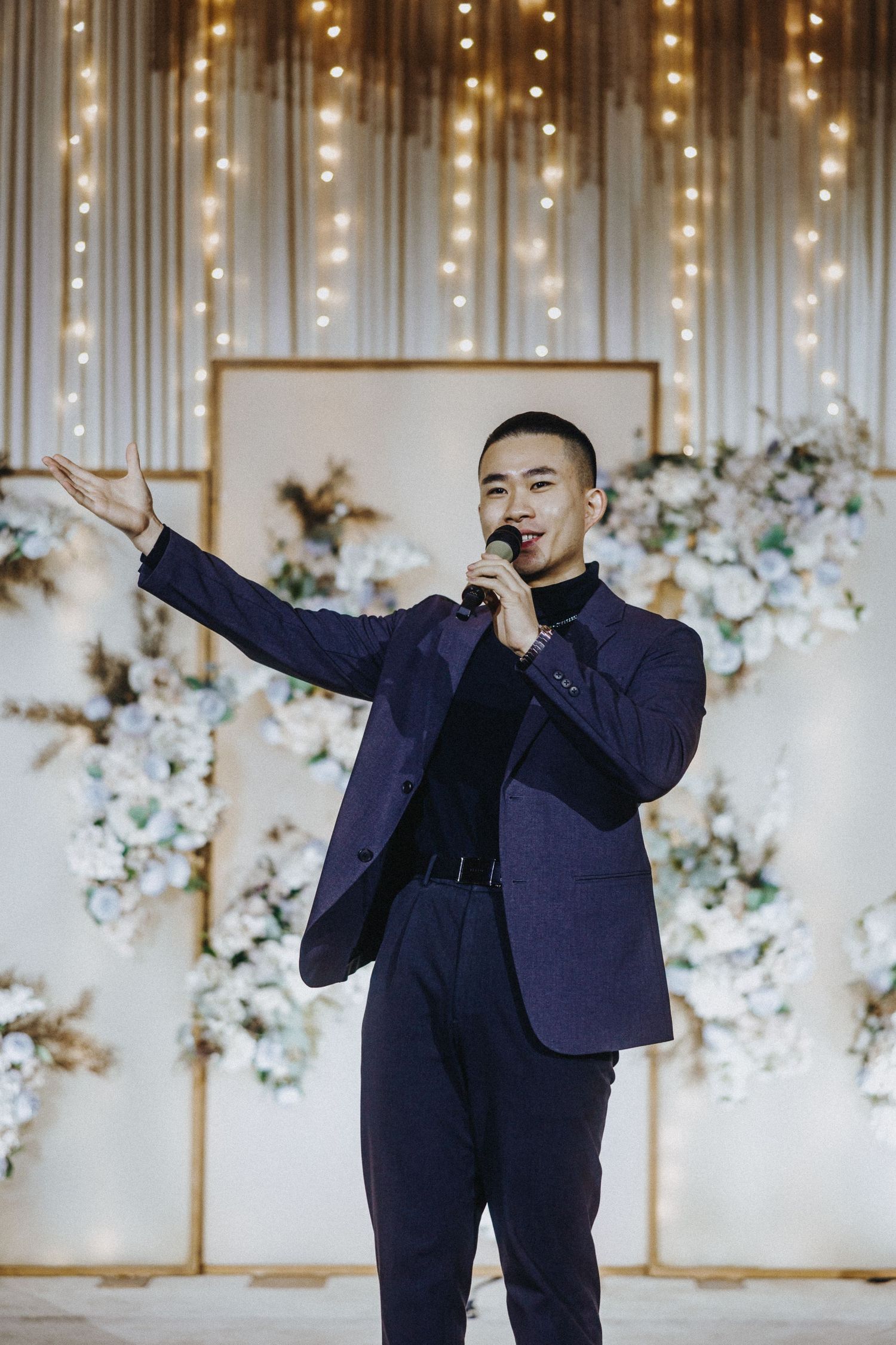 A photo series showing a person in a navy suit striking dynamic poses against a decorated backdrop.