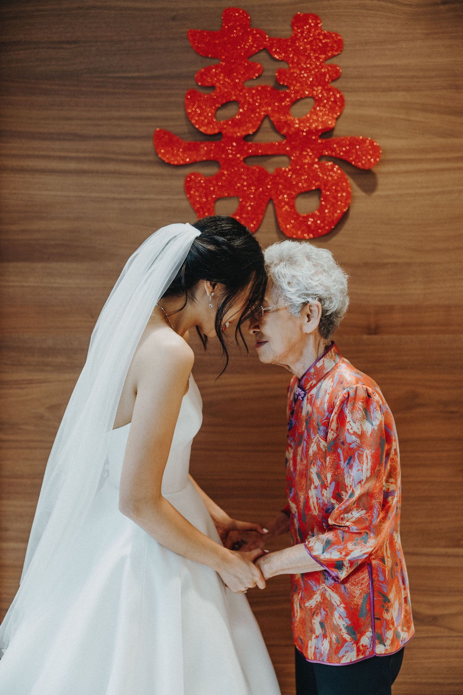 Wedding ceremony using traditional Chinese double happiness symbols and decor.