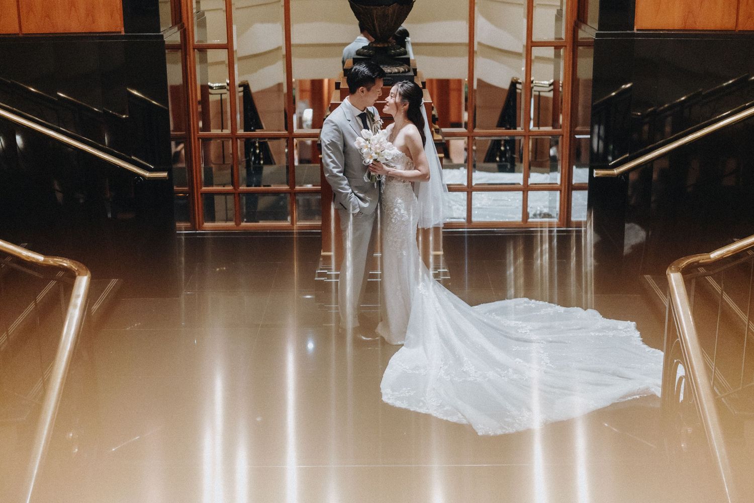 Elegant wedding venue with warm wood accents and dramatic lighting.