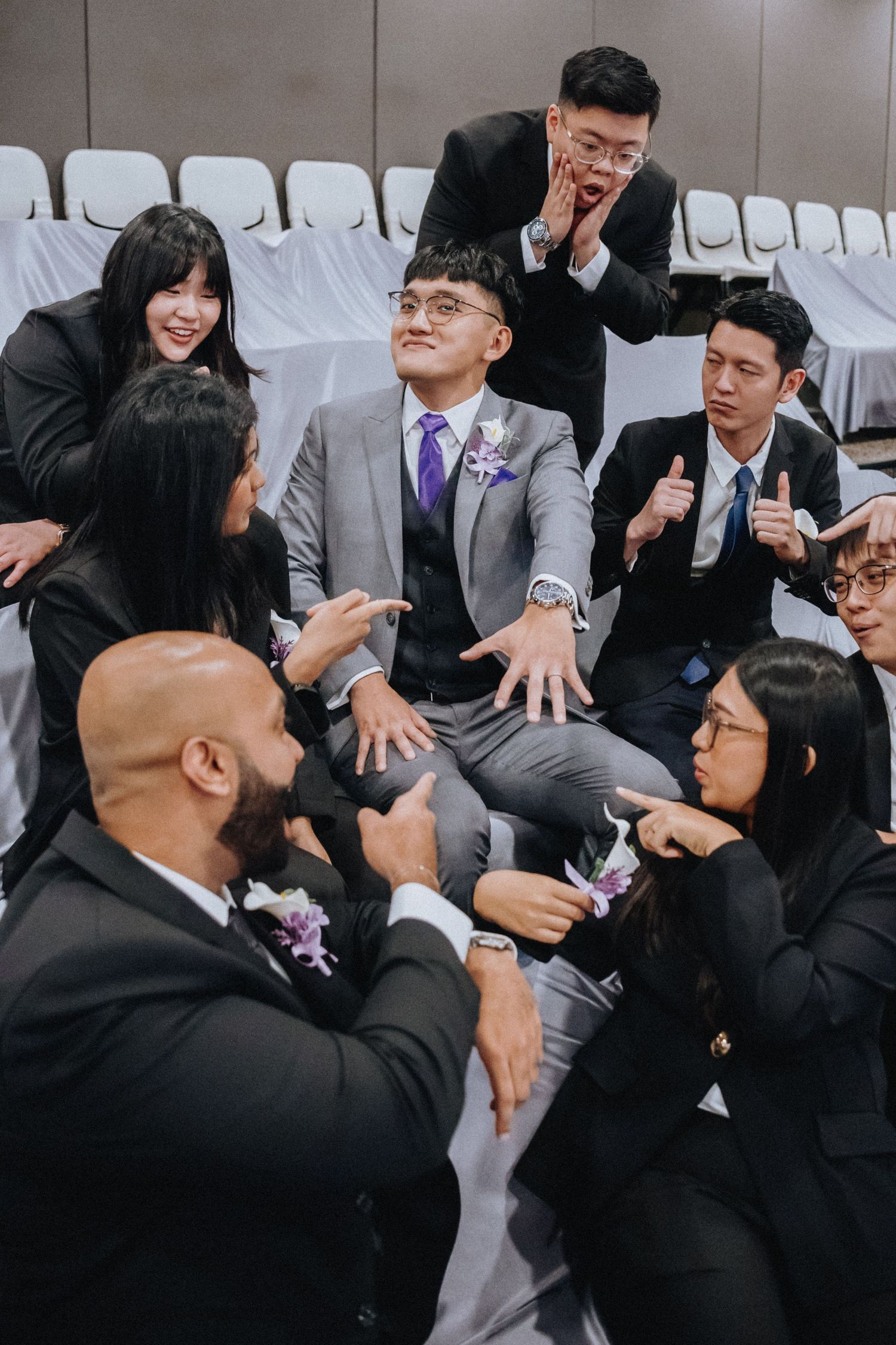 Wedding guests share laughter and joyful reactions during an emotional moment at the ceremony.