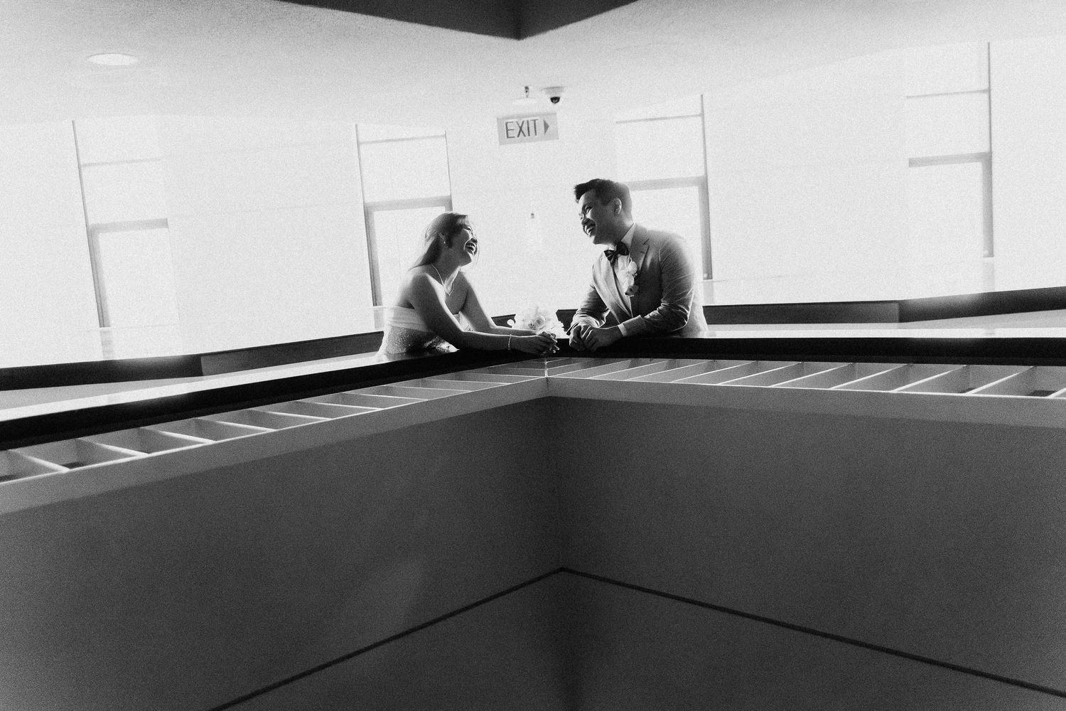 Black and white interior shot showing minimalist empty room with white walls.