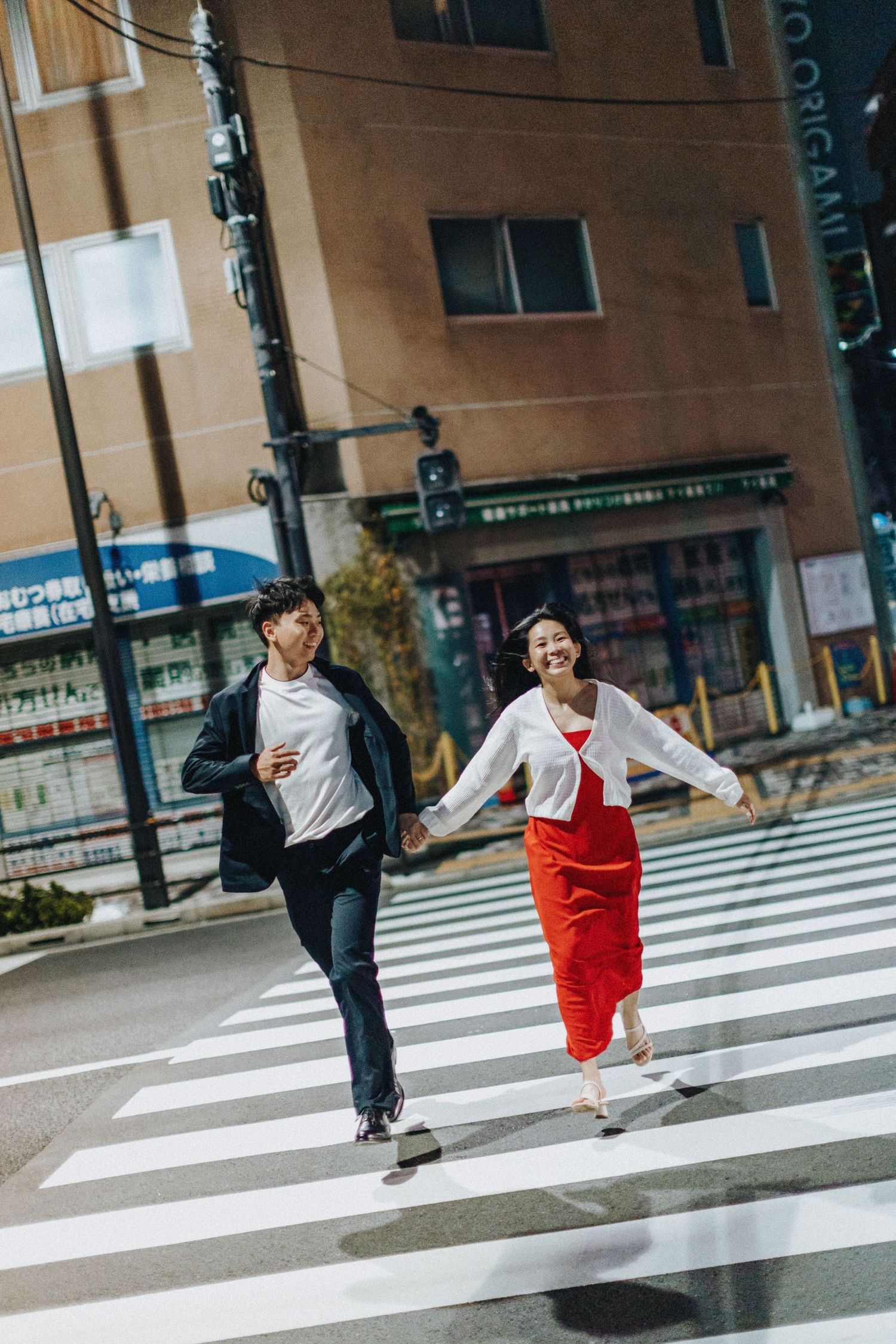 People crossing a zebra crossing in dynamic walking poses on a city street.