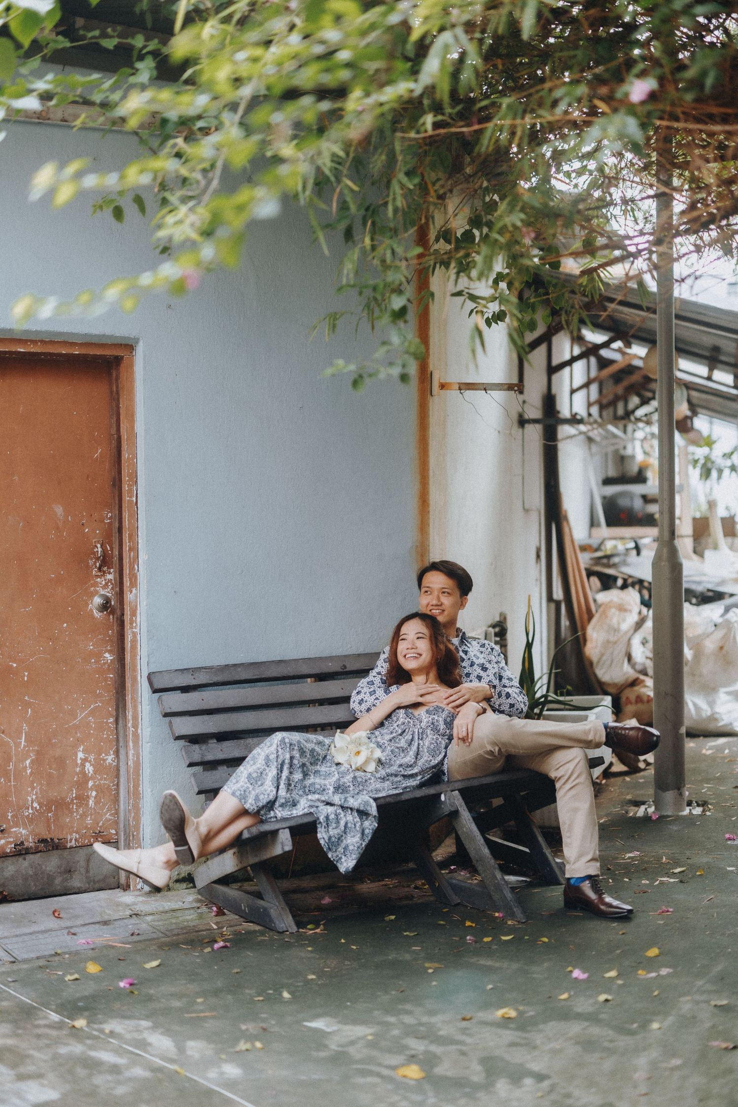 A series of playful poses captured from different angles on a rustic porch with leaves in the background.