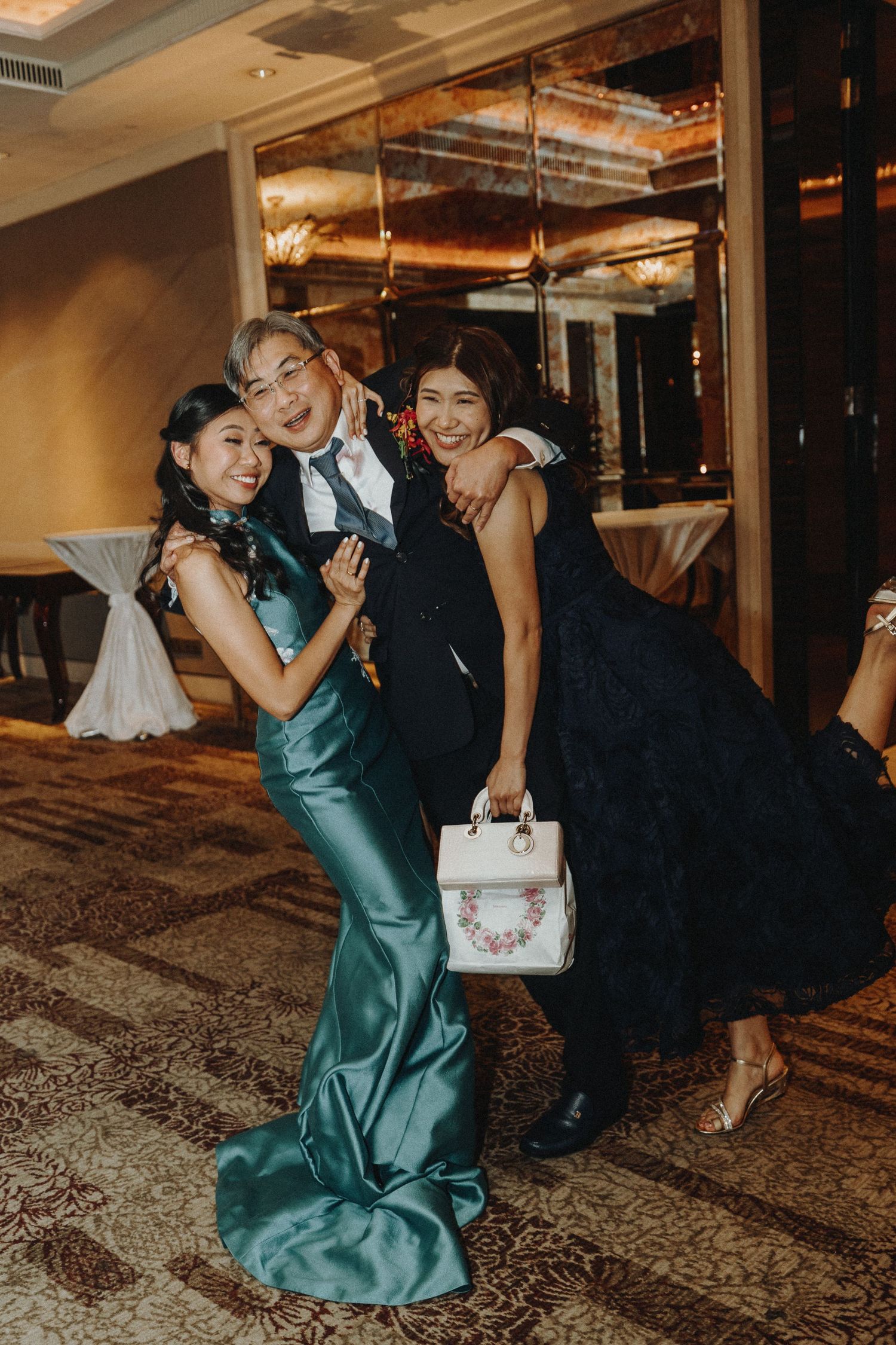 Wedding celebration moment captured in indoor venue with elegant formal attire.