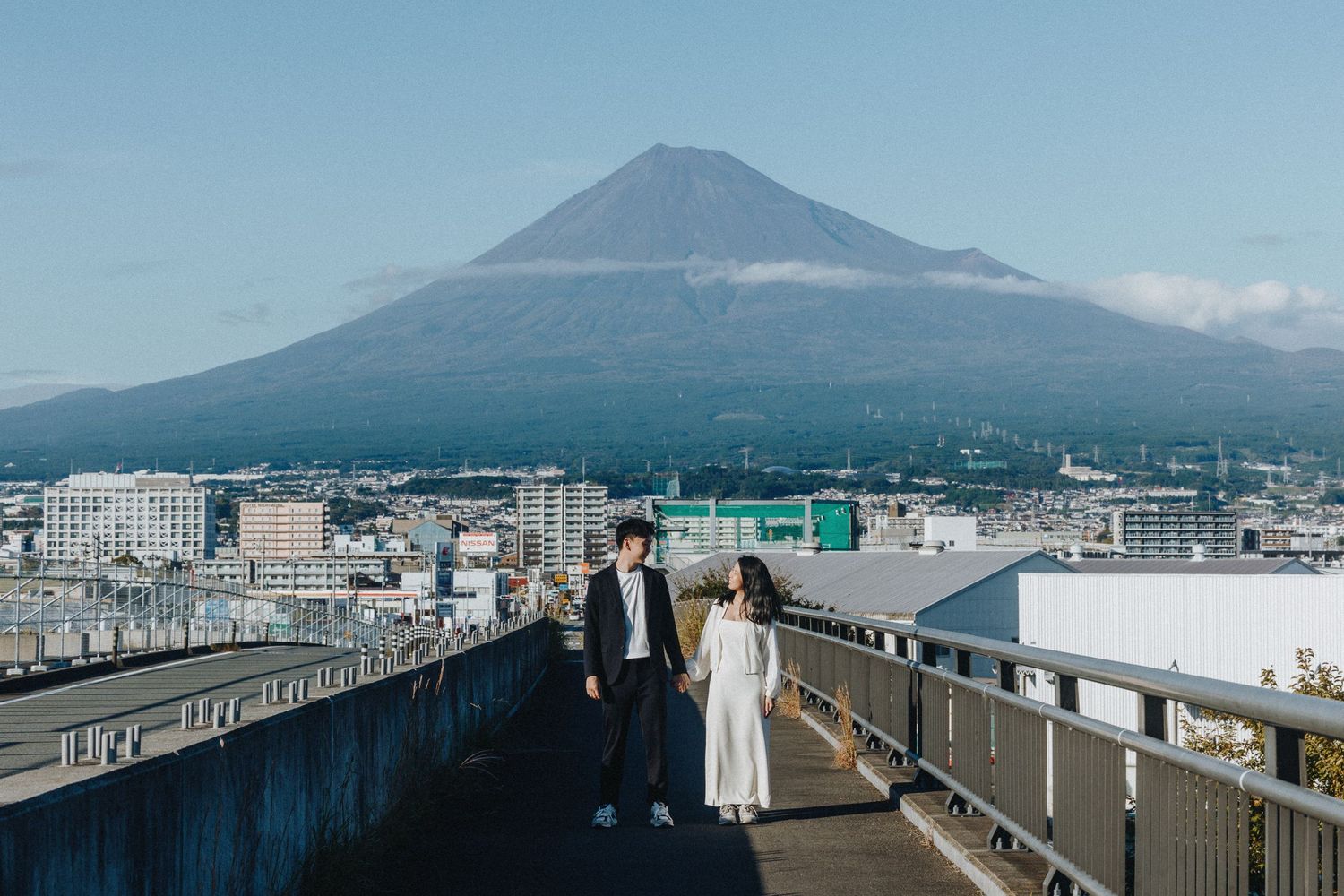Panoramic cityscape view with Mount Fuji rising majestically in the background.