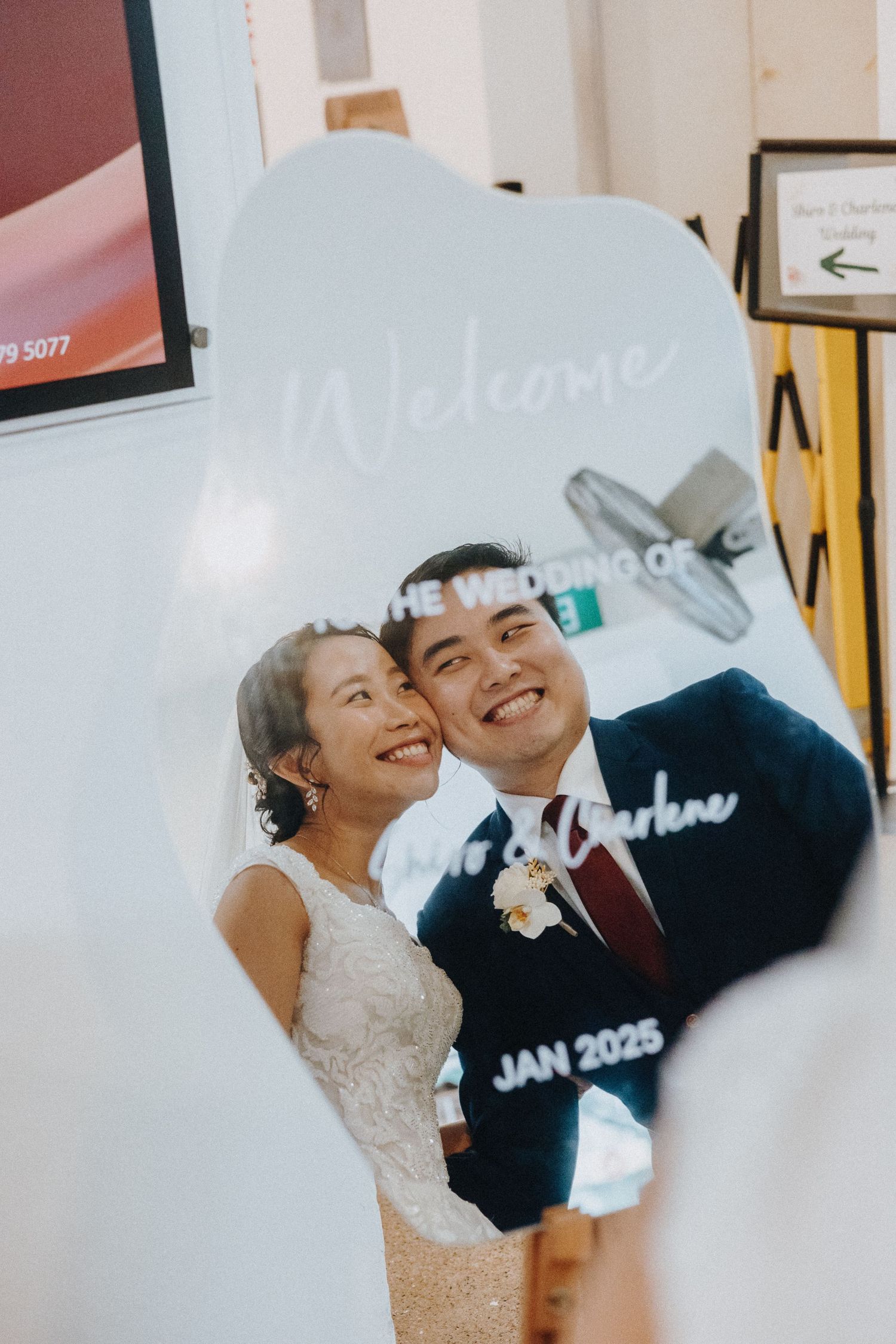 A couple sharing a happy moment in front of a wedding date display.