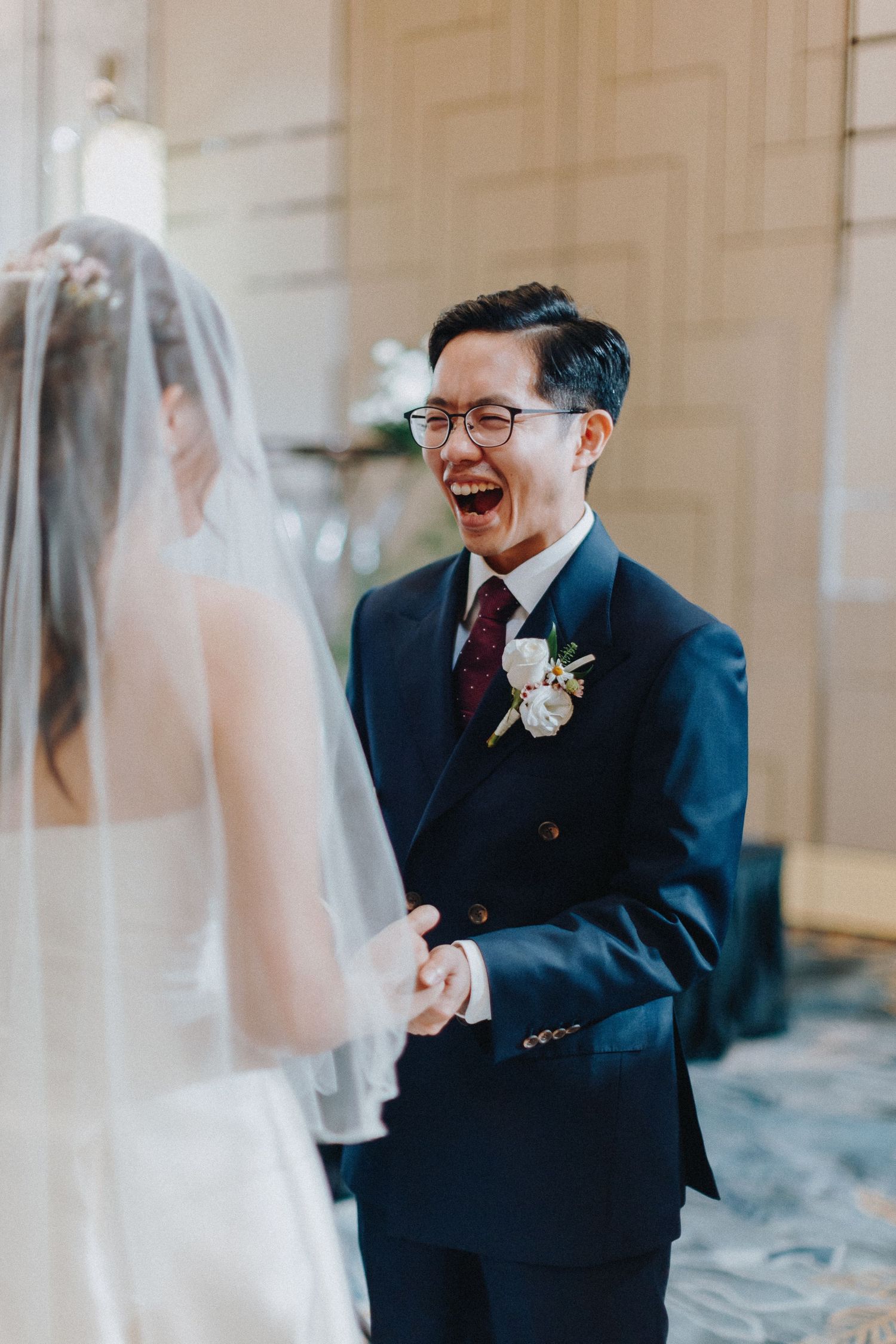 Emotional first look moment between couple in formal wedding attire.